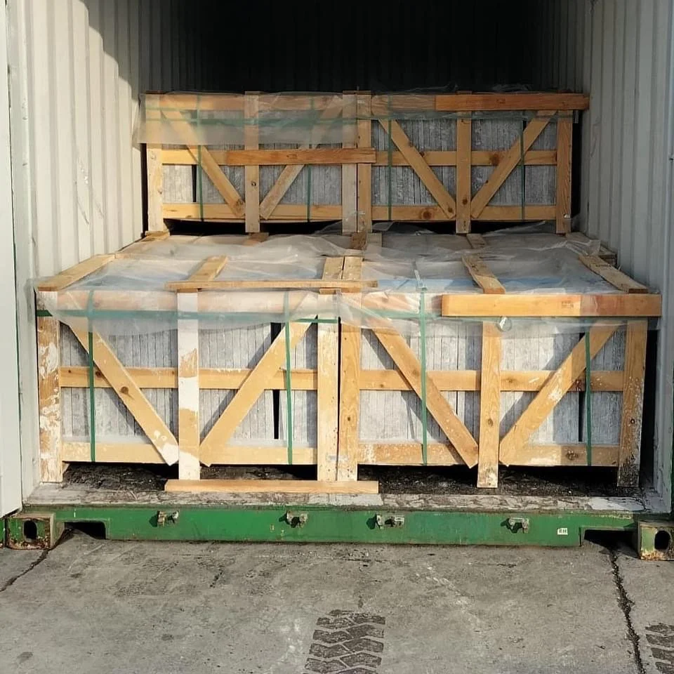 Wooden crate of G STONE marble being loaded into a shipping container for export