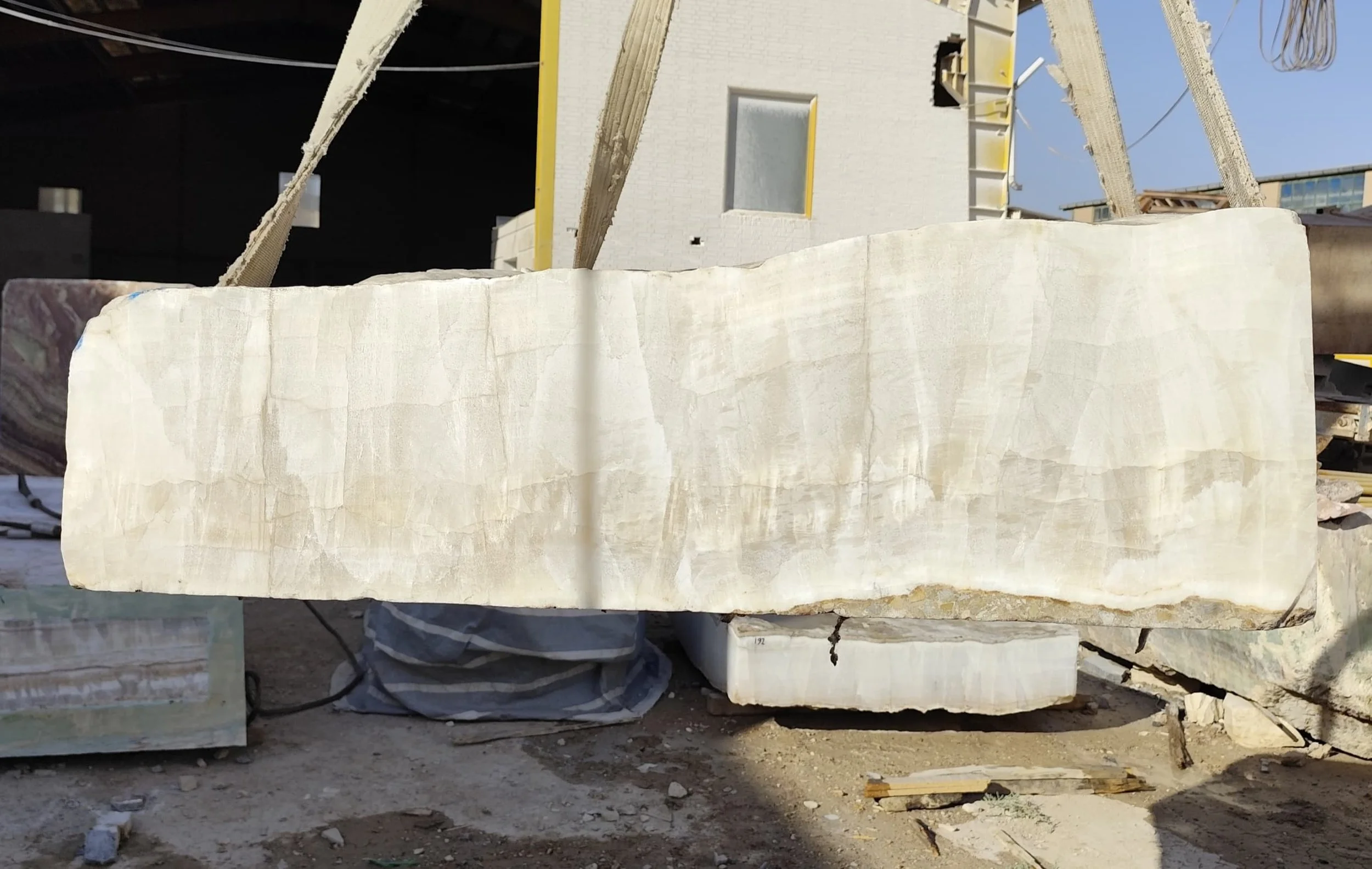 Raw stone block being lifted at the G STONE quarry yard