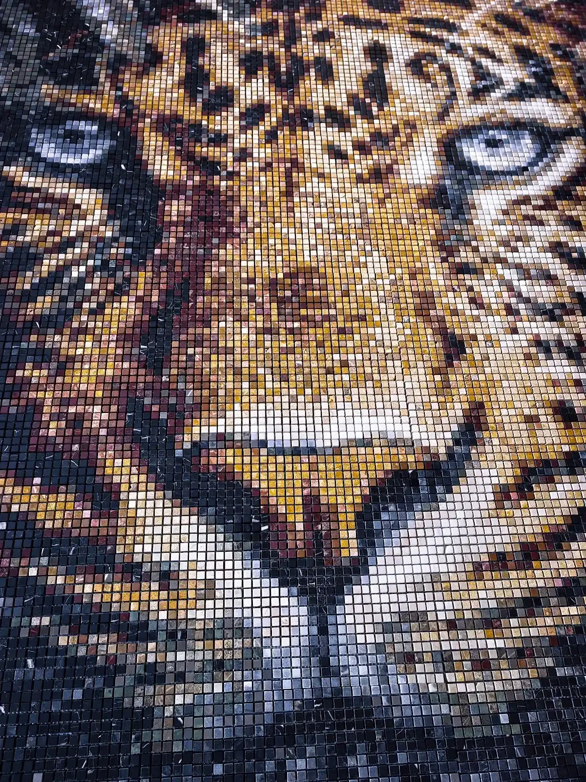 Leopard portrait in natural stone mosaic, assembled from individual stone tesserae