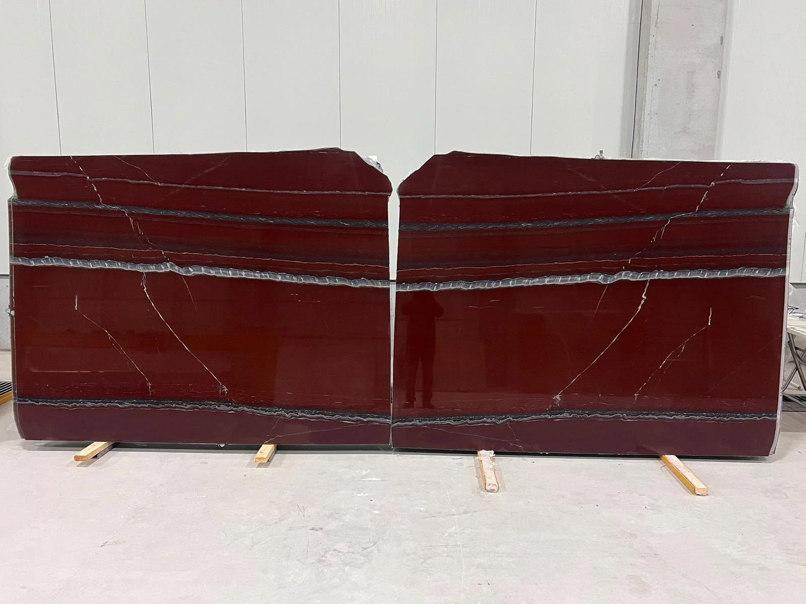 Polished red marble slabs on the cutting machine at G STONE's factory