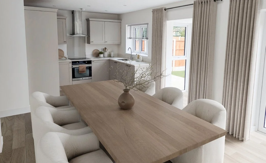 Kitchen and dining area with a wooden table, six upholstered chairs, a vase with branches, light-colored curtains, a window, a sliding glass door, and a modern white kitchen with light gray cabinets and a small window.