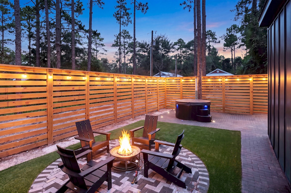 Evening exterior view of fire pit and hot tub