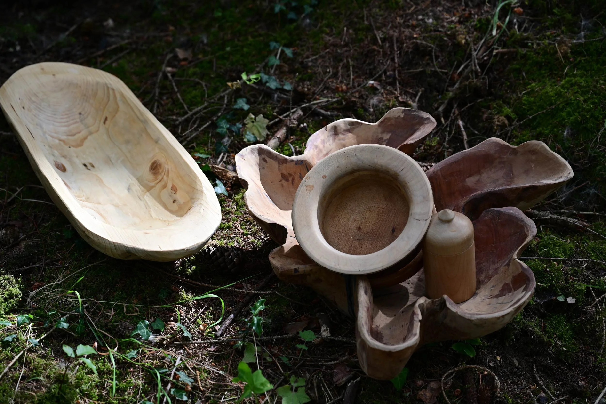 Turned and carved work side by side — the evolution from lathe to axe.