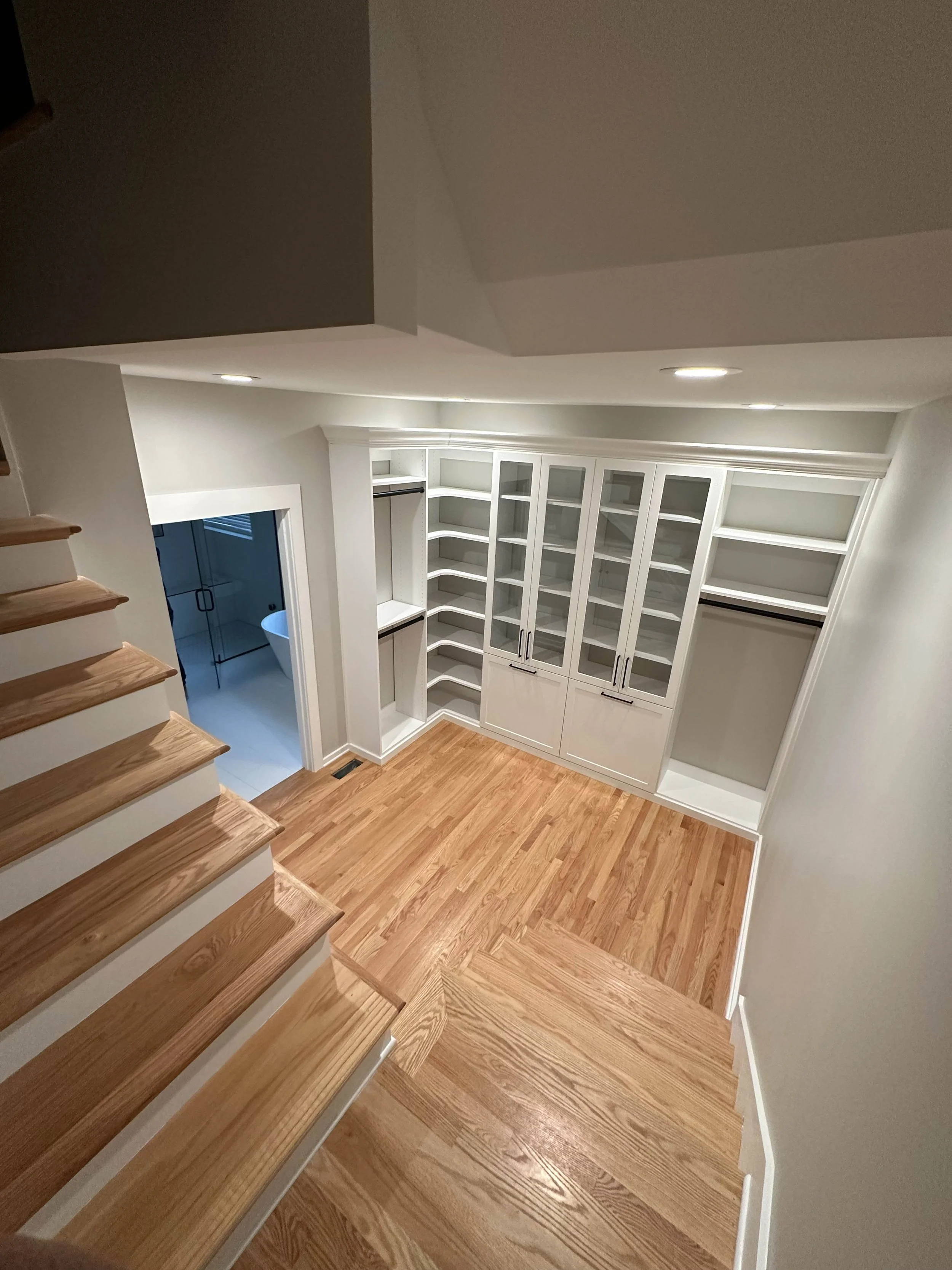 Custom built-in cabinetry and storage with hardwood flooring