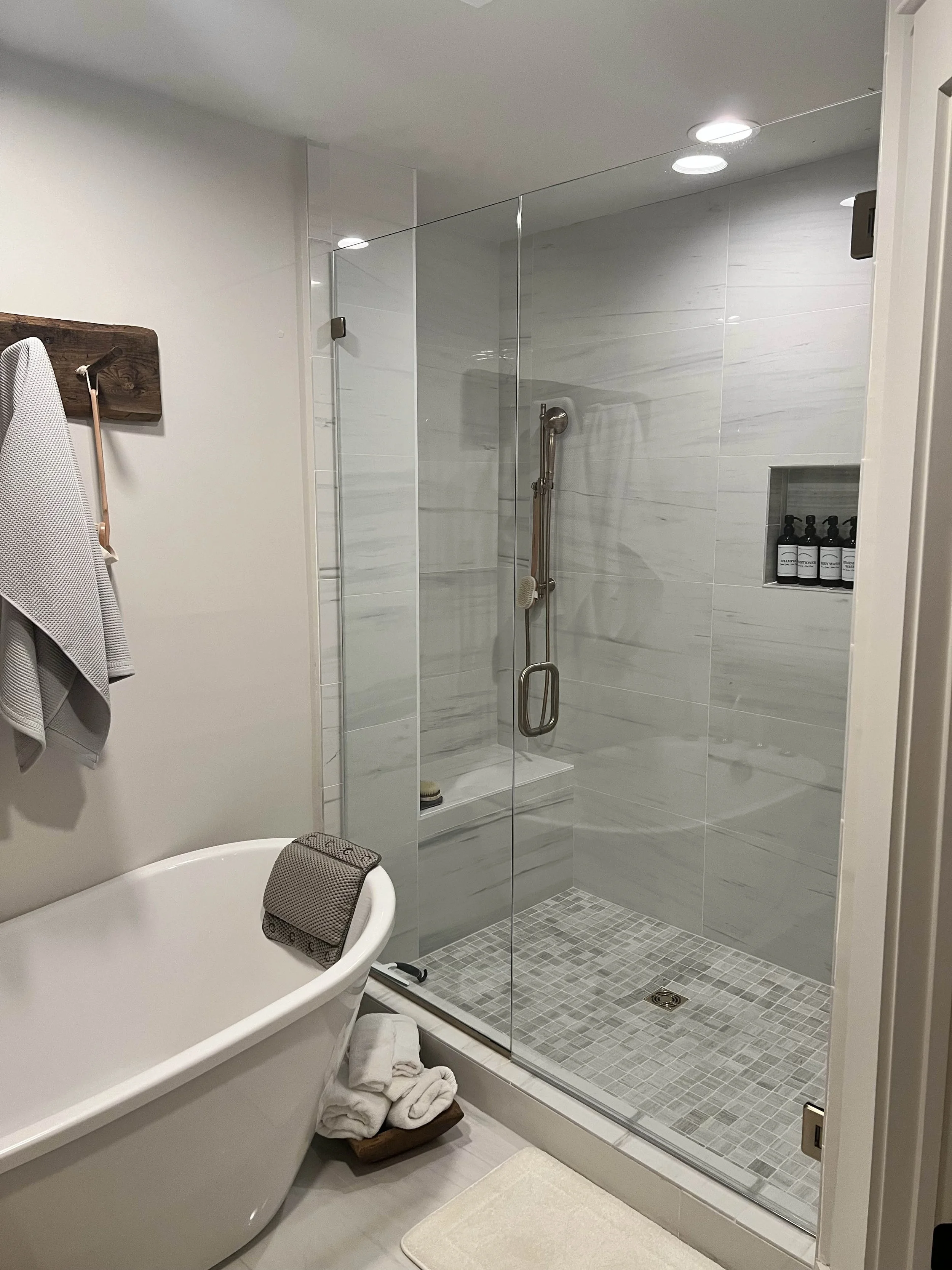 Bathroom renovation with freestanding soaking tub and glass walk-in shower