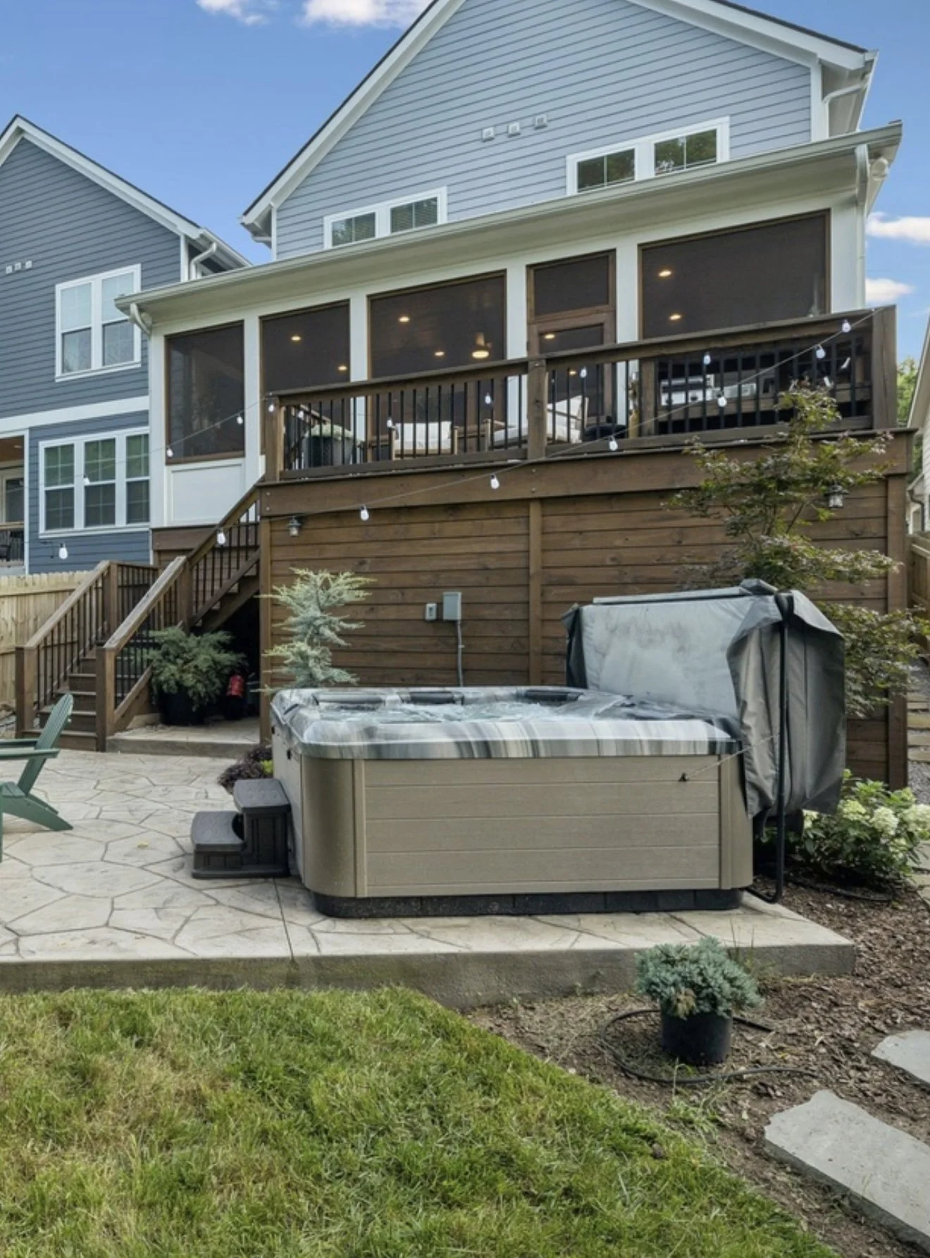 Custom screened porch and elevated deck addition on residential home, concrete patio, landscaping, metal roof & irrigation system