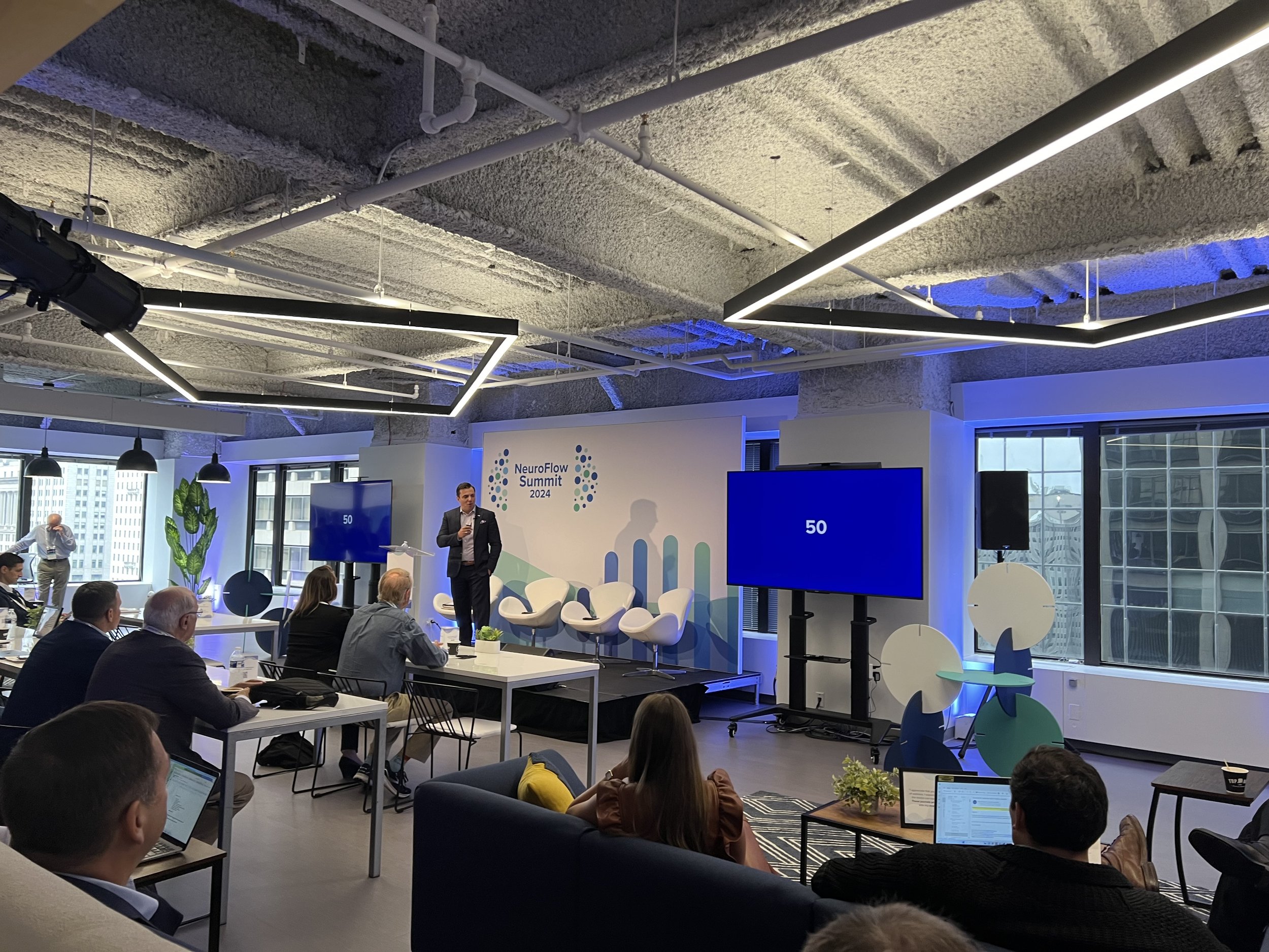 Corporate conference attendees at NeuroFlow Client Summit 2024 in Philadelphia with speaker and professional event staging