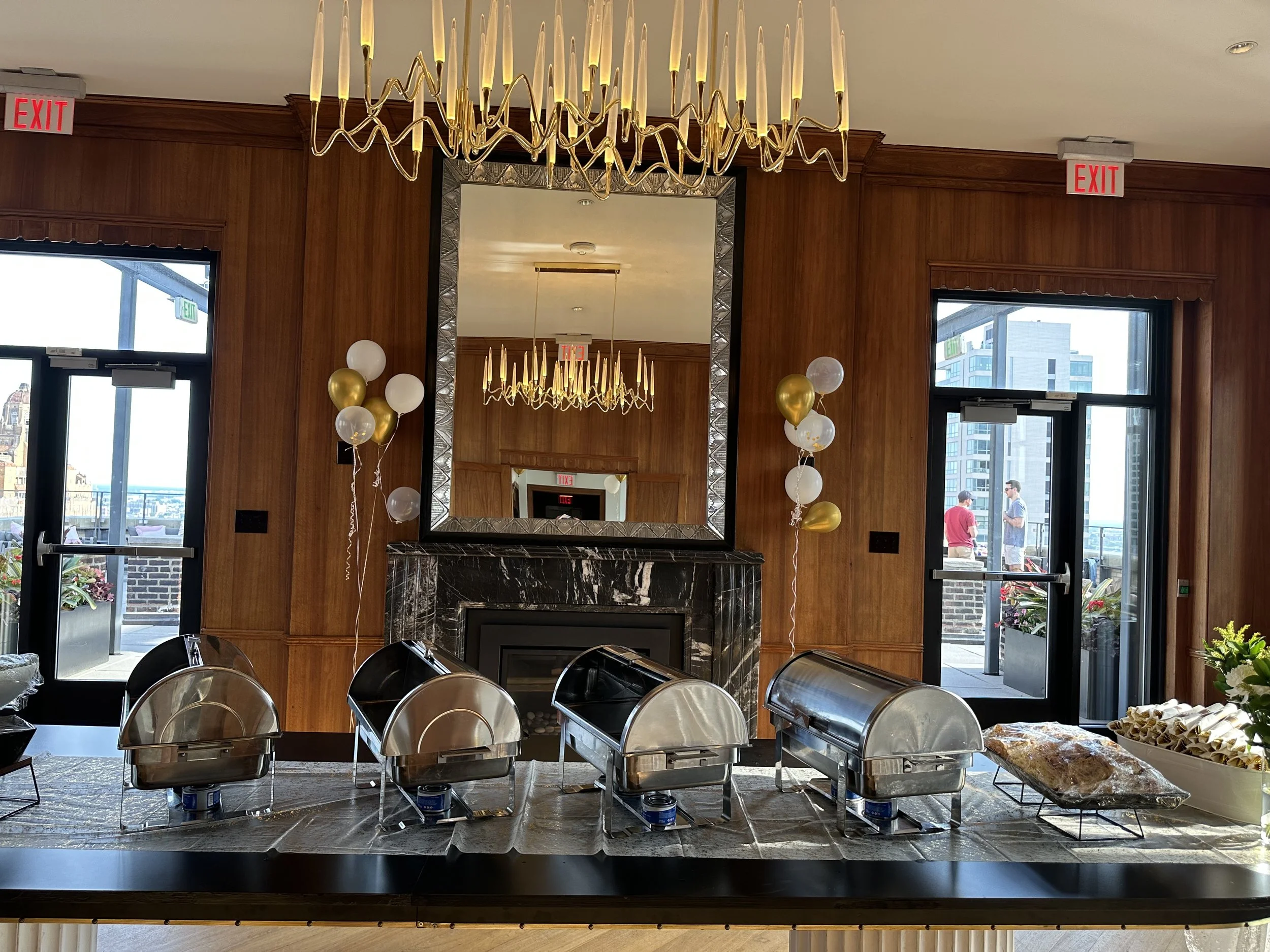 Elegant engagement party setup with catered food and chafing dishes