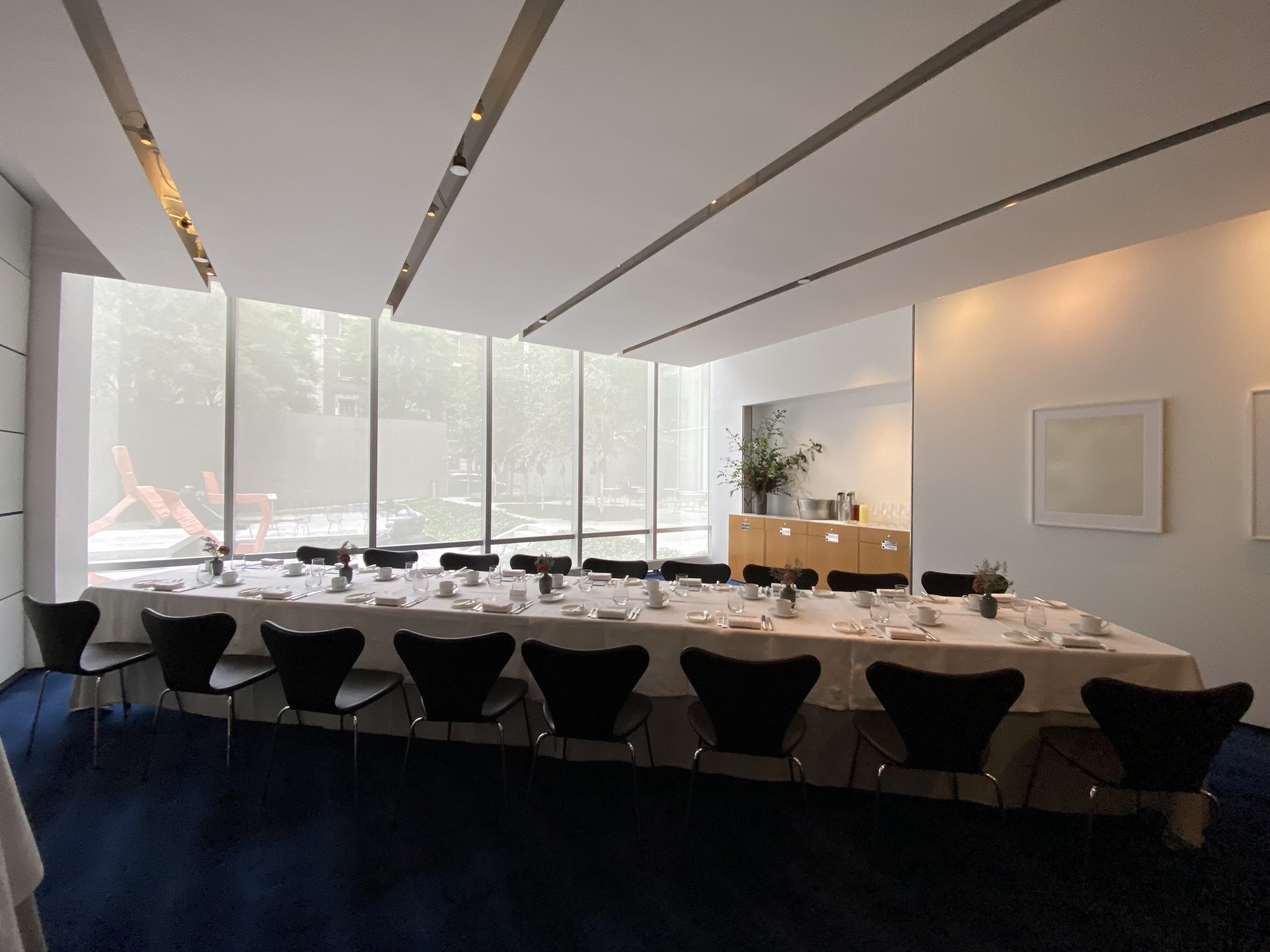 A corporate luncheon set up for executives in a private room at a Michelin Star restaurant in New York City