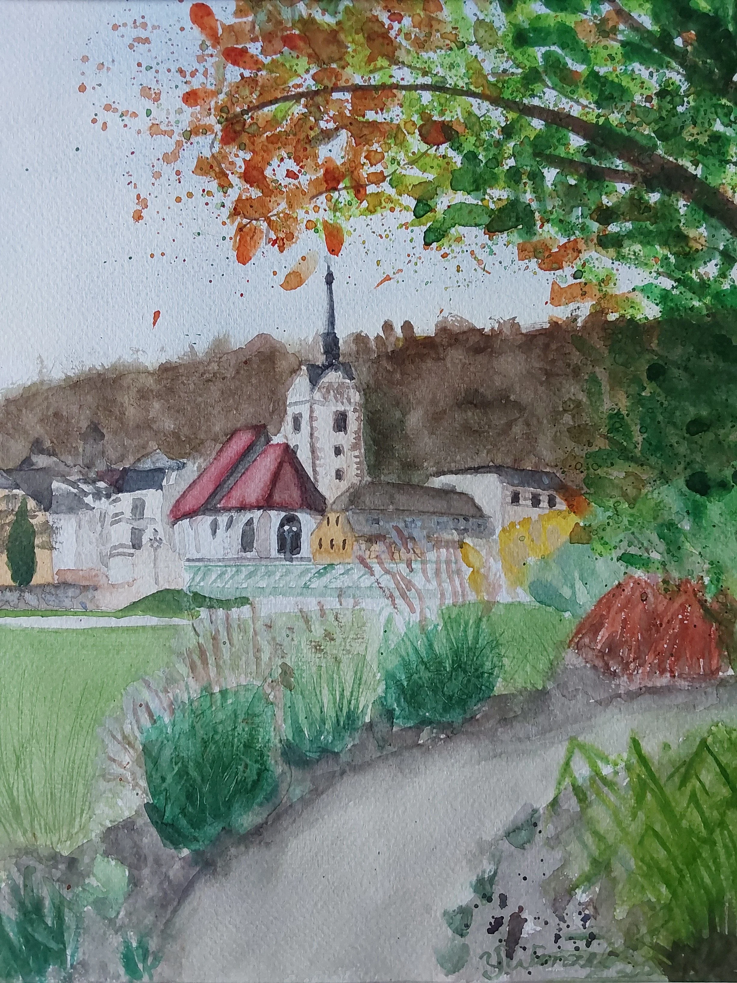 Herbst in der Guten Stube – Blick auf Untermhaus im Geraer Hofwiesenpark. Bäume mit leuchtendem Herbstlaub und Gräser säumen den Weg und tauchen die Landschaft in eine warme Herbststimmung.