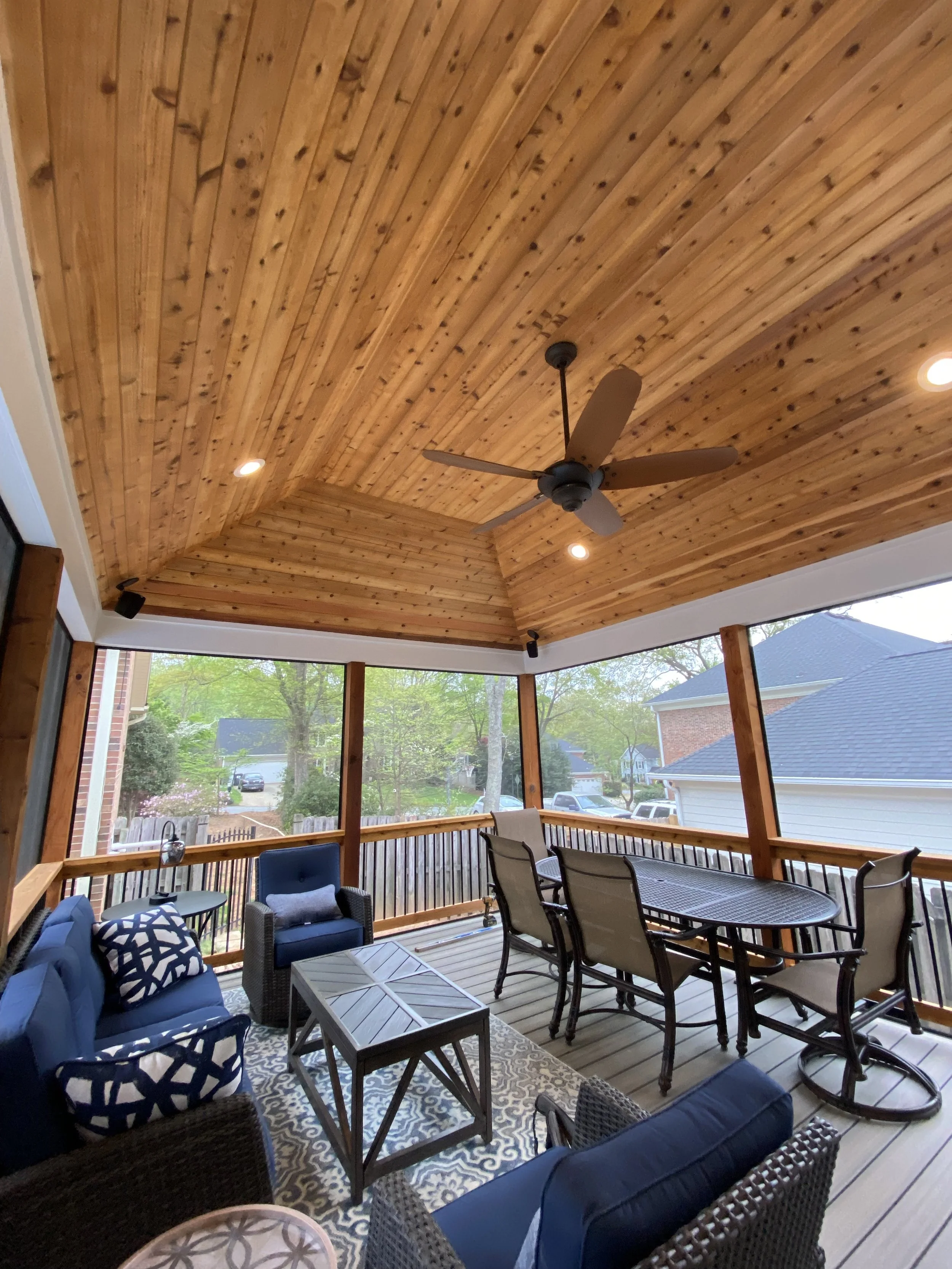 Detached pool house private screened in porch. Screen-Eze screen system installed on outside of cedar handrails with aluminum balusters. Vaulted cedar tongue and groove ceiling.