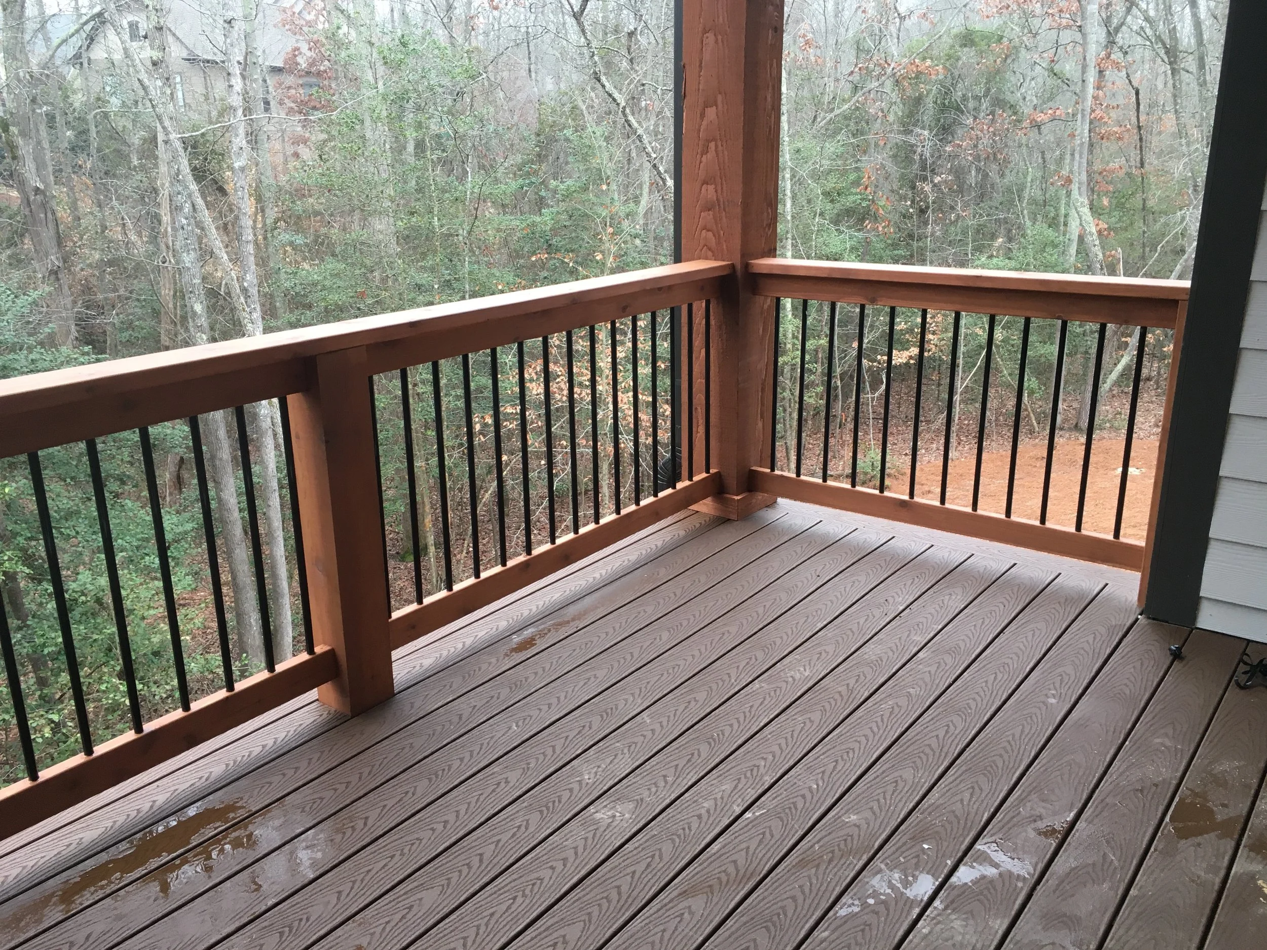 Trex select composite decking and cedar handrails with aluminum balusters. Screen-Eze screen track system installed on outside handrails.