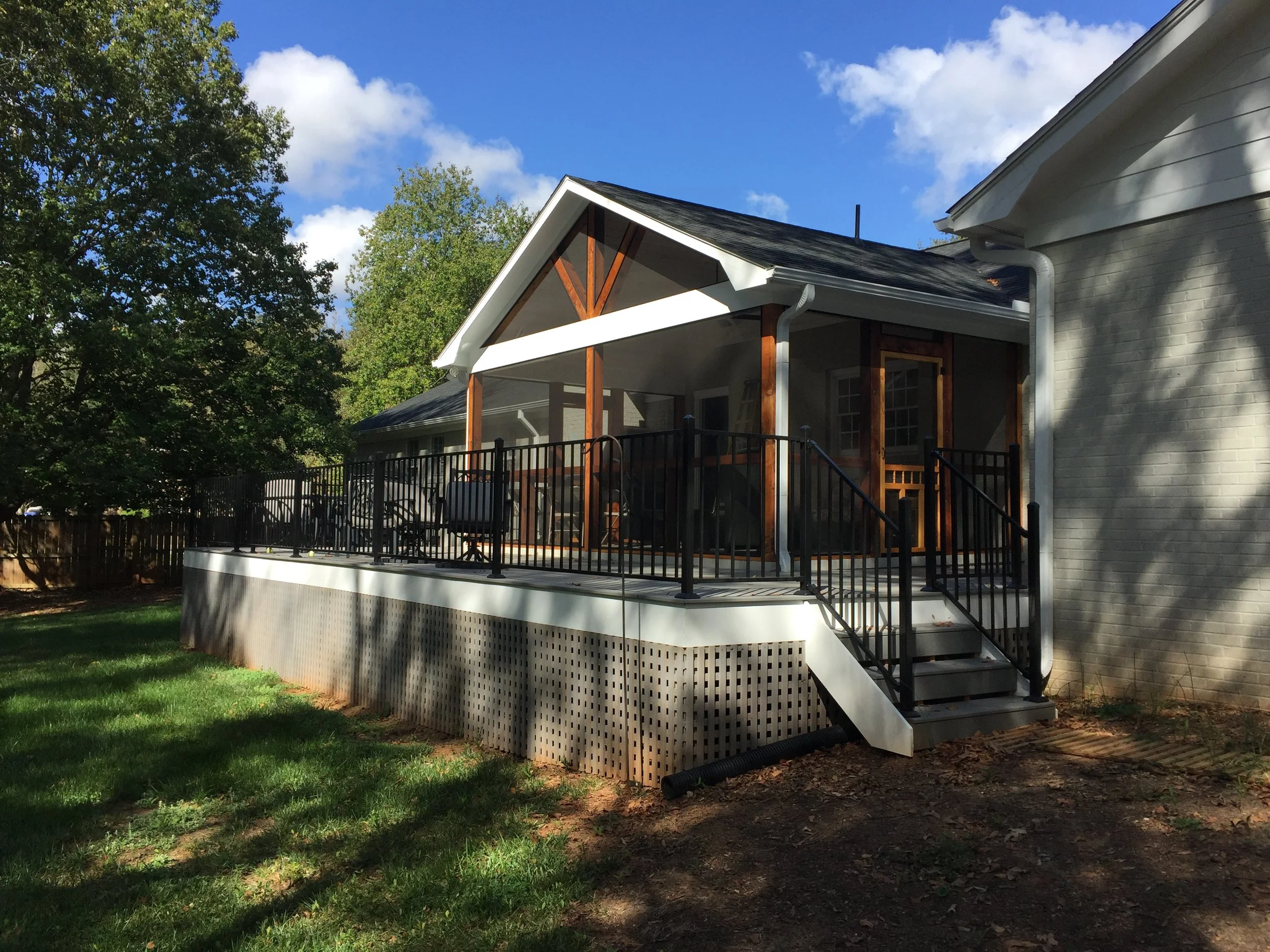 Screened in porch using Screen-Eze system. Trex Select composite decking with aluminum Fortress handrail. Heavy duty square lattice under perimeter of deck. 