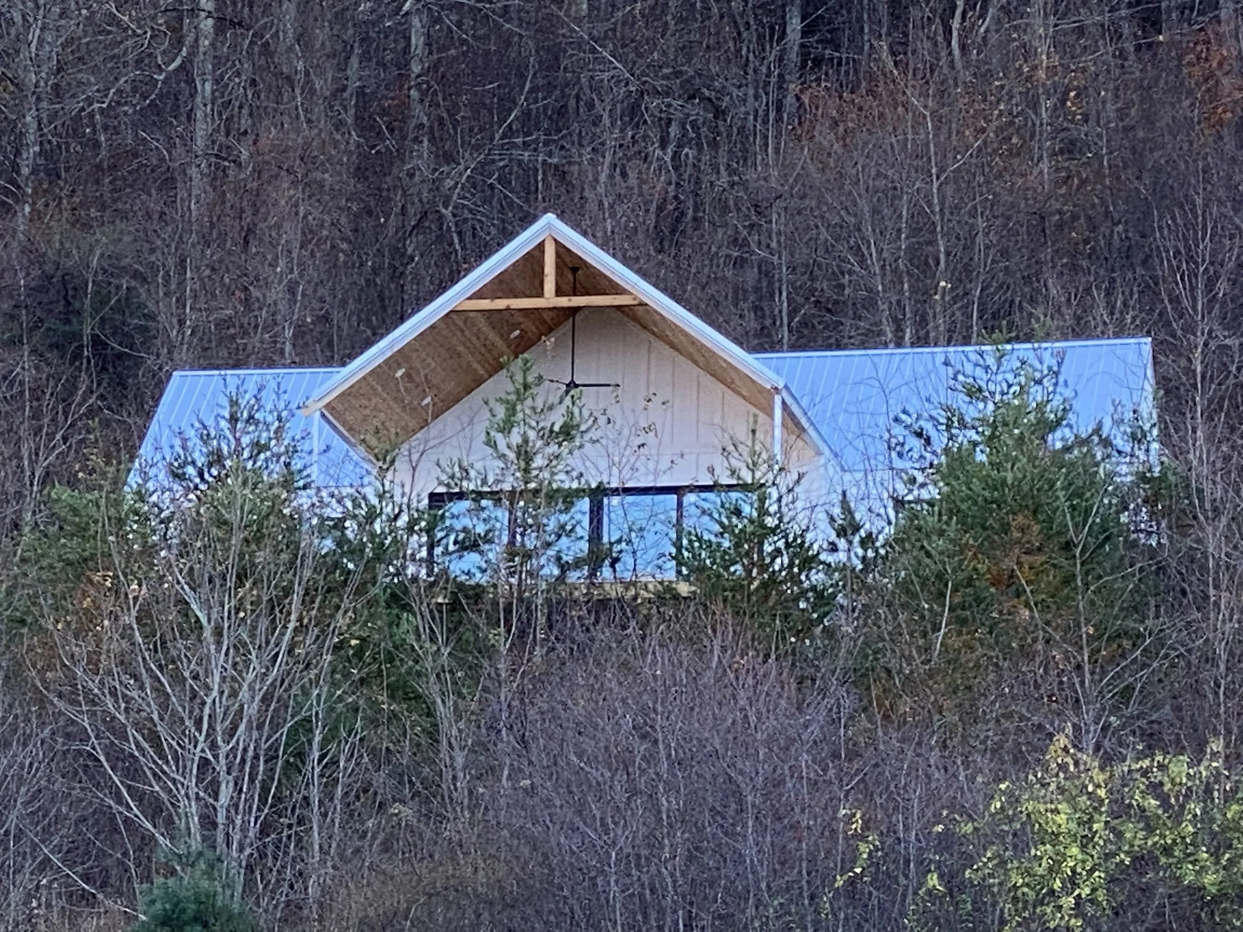 1x6 cedar tongue and groove board installed on front porch ceiling. Structural 4x6 cedar collar tie with king post. LED recessed can lights and ceiling fan. Fiber cement board and baton siding.