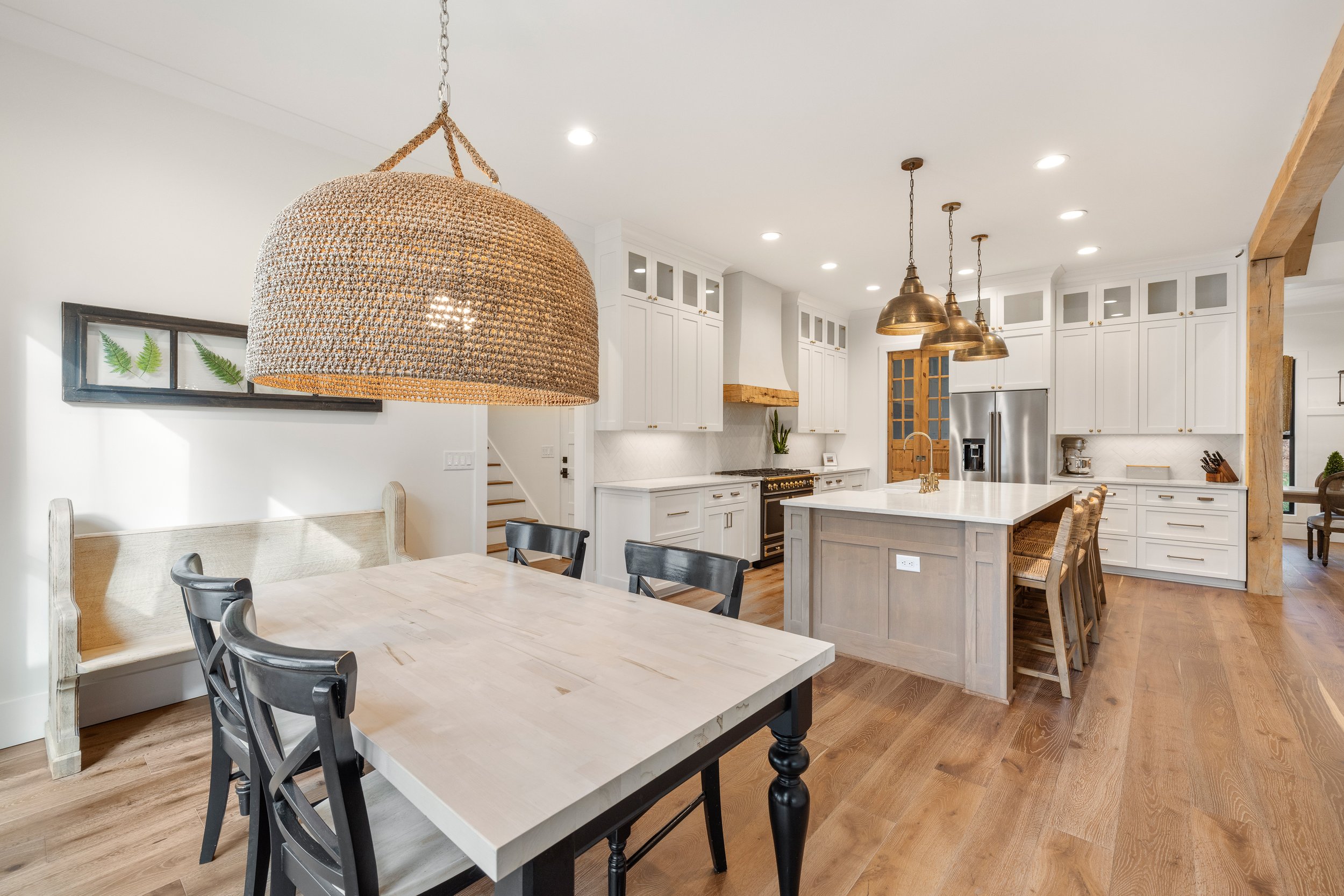 Custom cabinetry. Custom site built arched stucco coated hood vent with reclaimed wood detail. 
