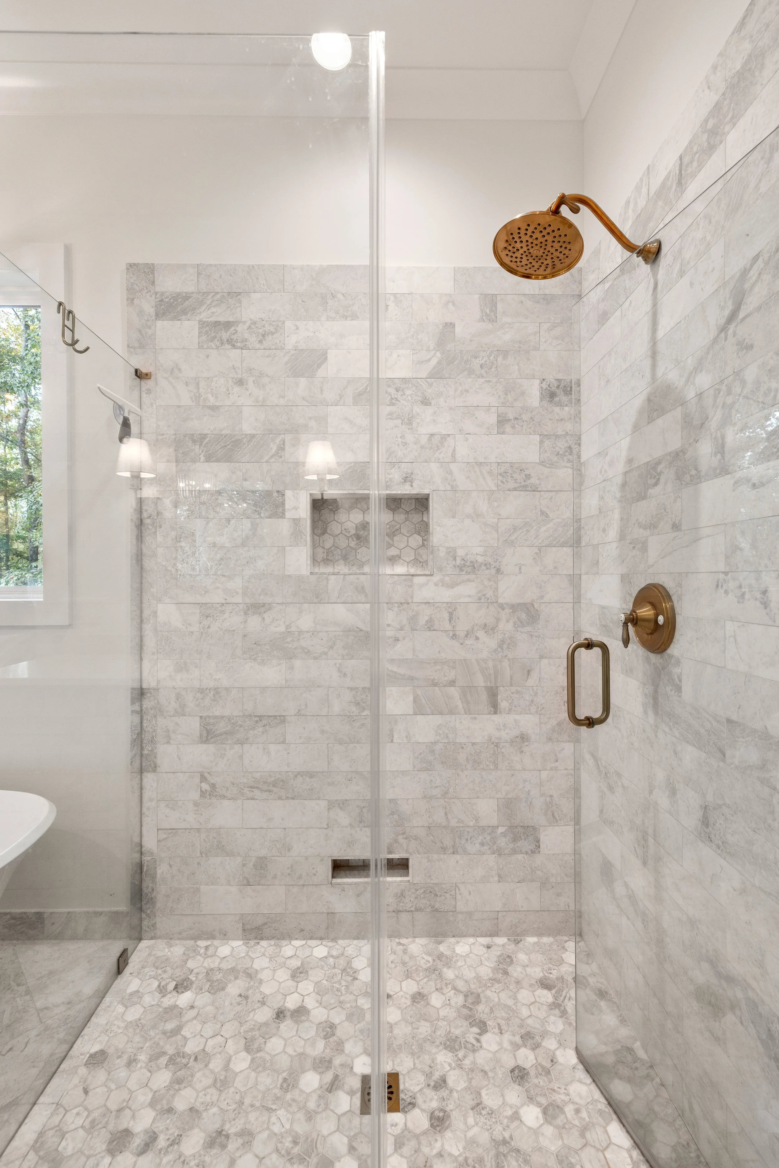 Curbless custom tile shower with frameless glass shower walls and door.