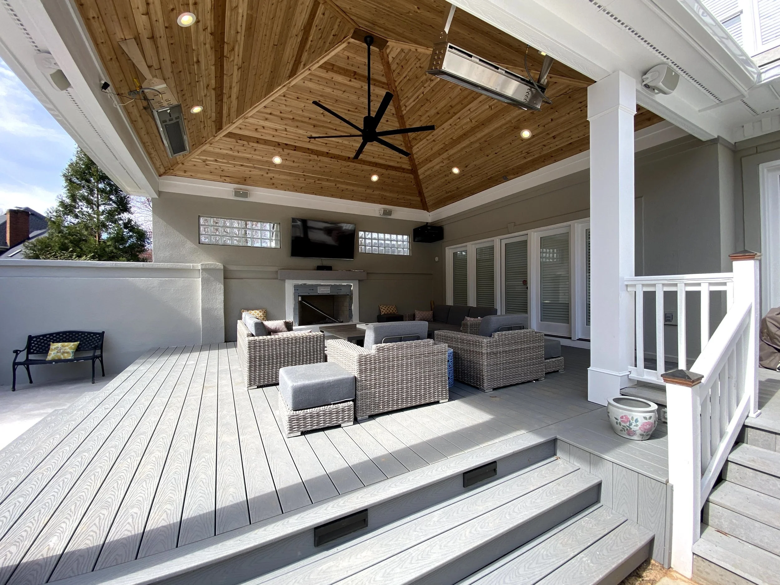 Trex Select decking. Riser lights on stairs. Cedar tongue and groove ceiling with gas outdoor ceiling mount heaters.