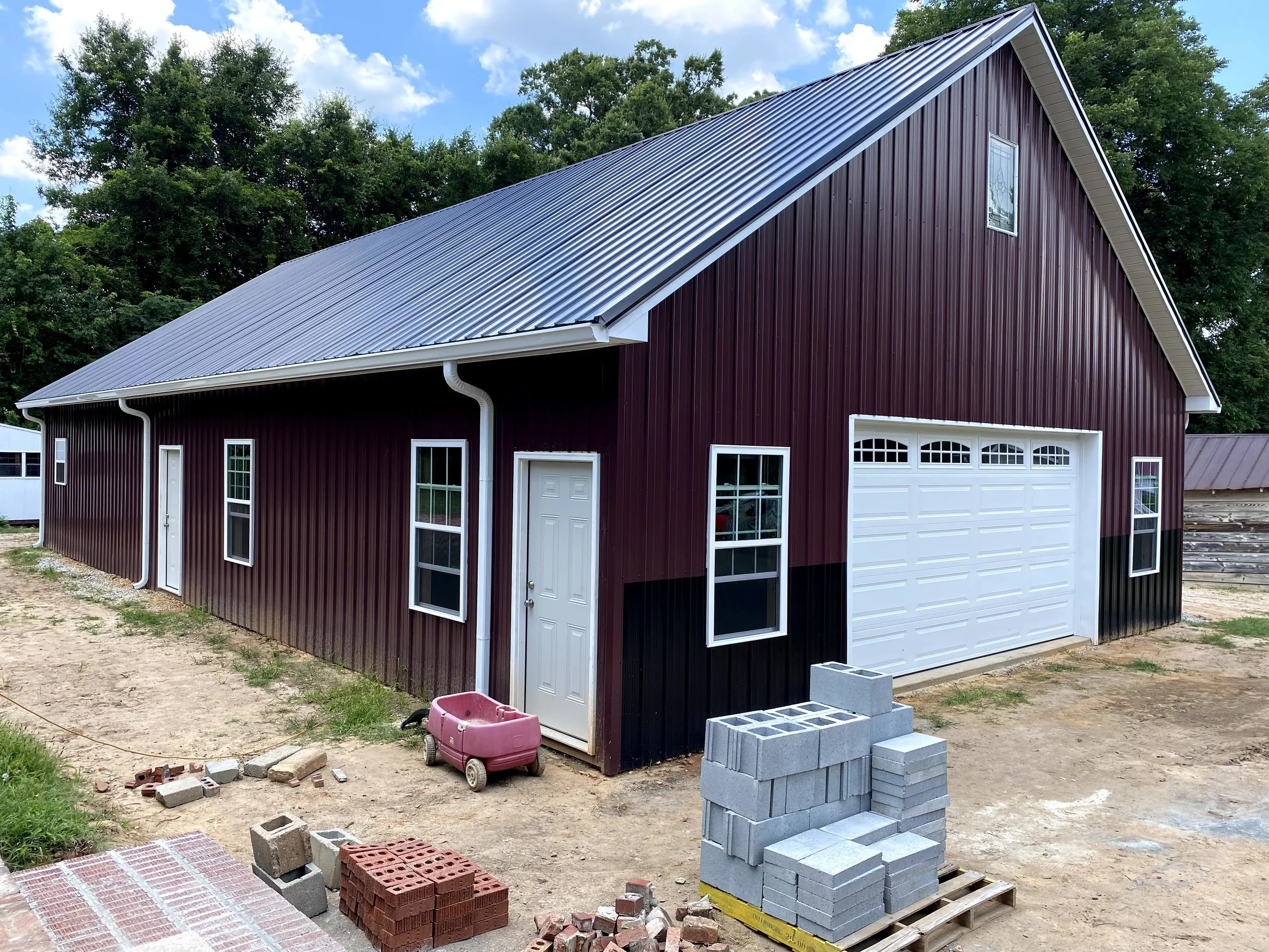 Large pole barn with metal Tough Rib metal roofing and siding. Vinyl windows.