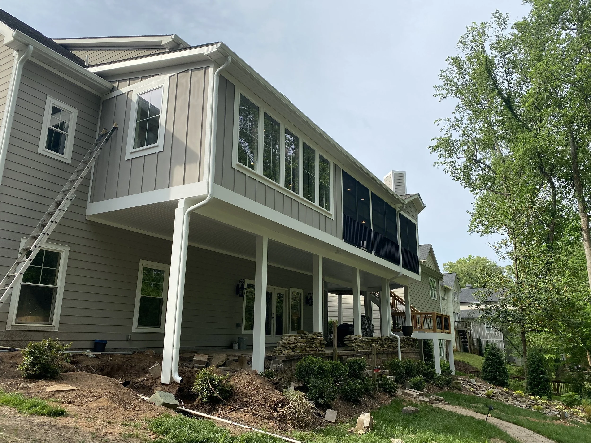 Large three season porch addition with dining room/sun room addition. Eze Breeze window system with aluminum safety rail outside window units. Fiber cement plank siding. 