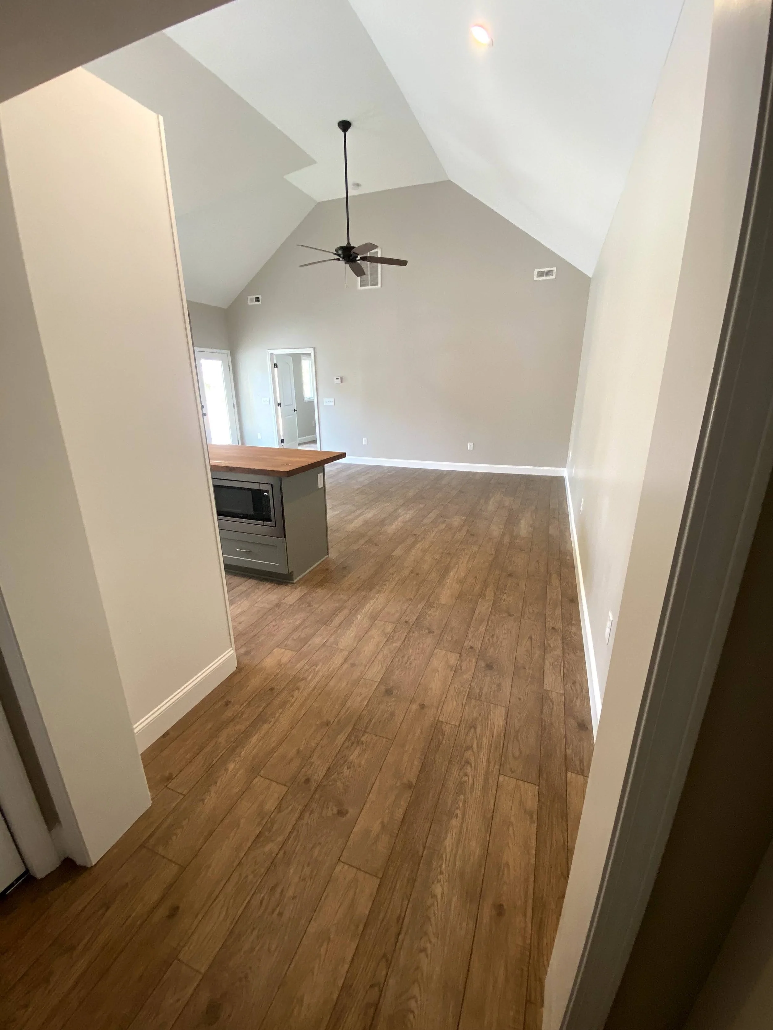 Interior of a pool house/mother in law suite built off the back of a detached garage. LVP flooring over slab foundation. 