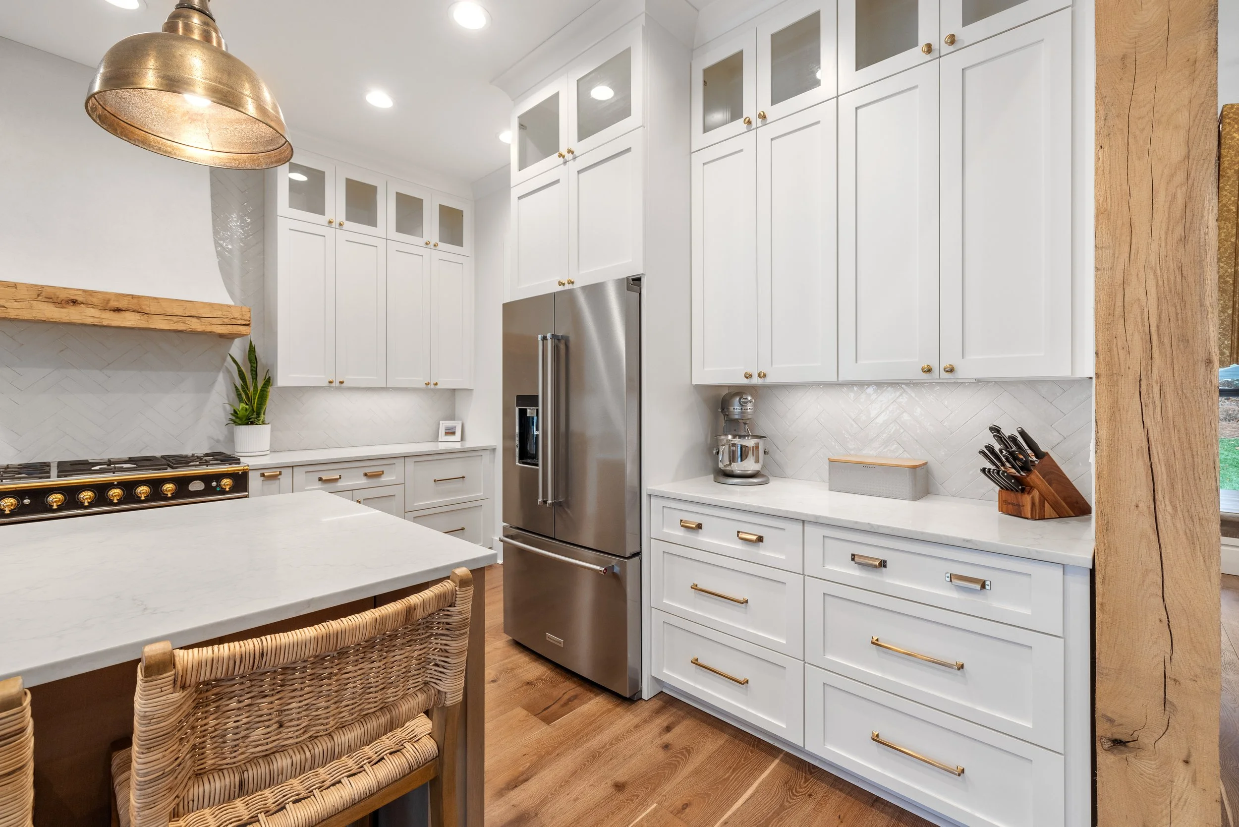 Custom cabinetry. Tile backsplash installed on a herringbone pattern.