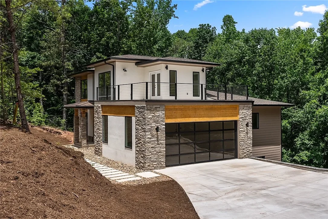 Stone veneer, stucco, and cedar tongue and groove accent siding. 18'x8 aluminum and glass garage door. Aluminum cable handrail on roof deck.