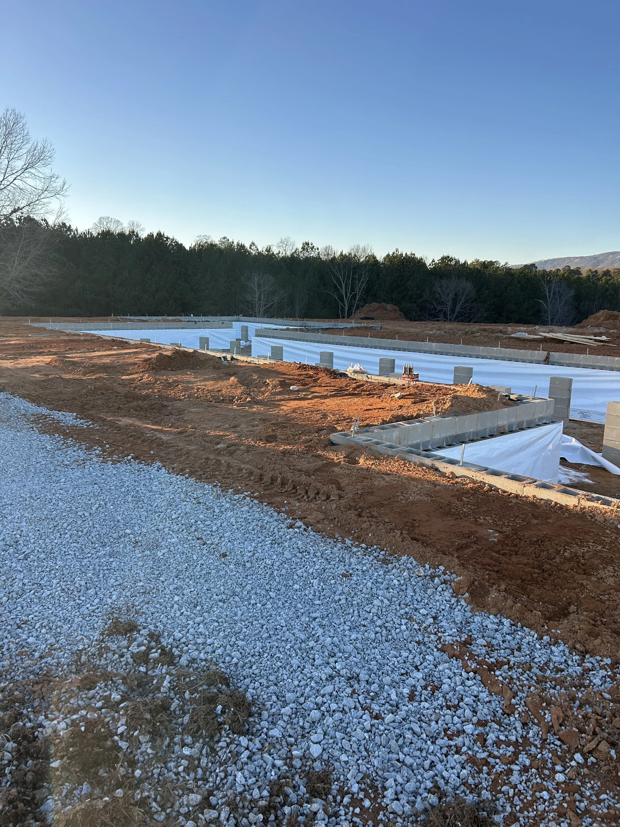 20mil poly installed on walls for beginning of crawlspace encapsulation. Foundation backfilled against.