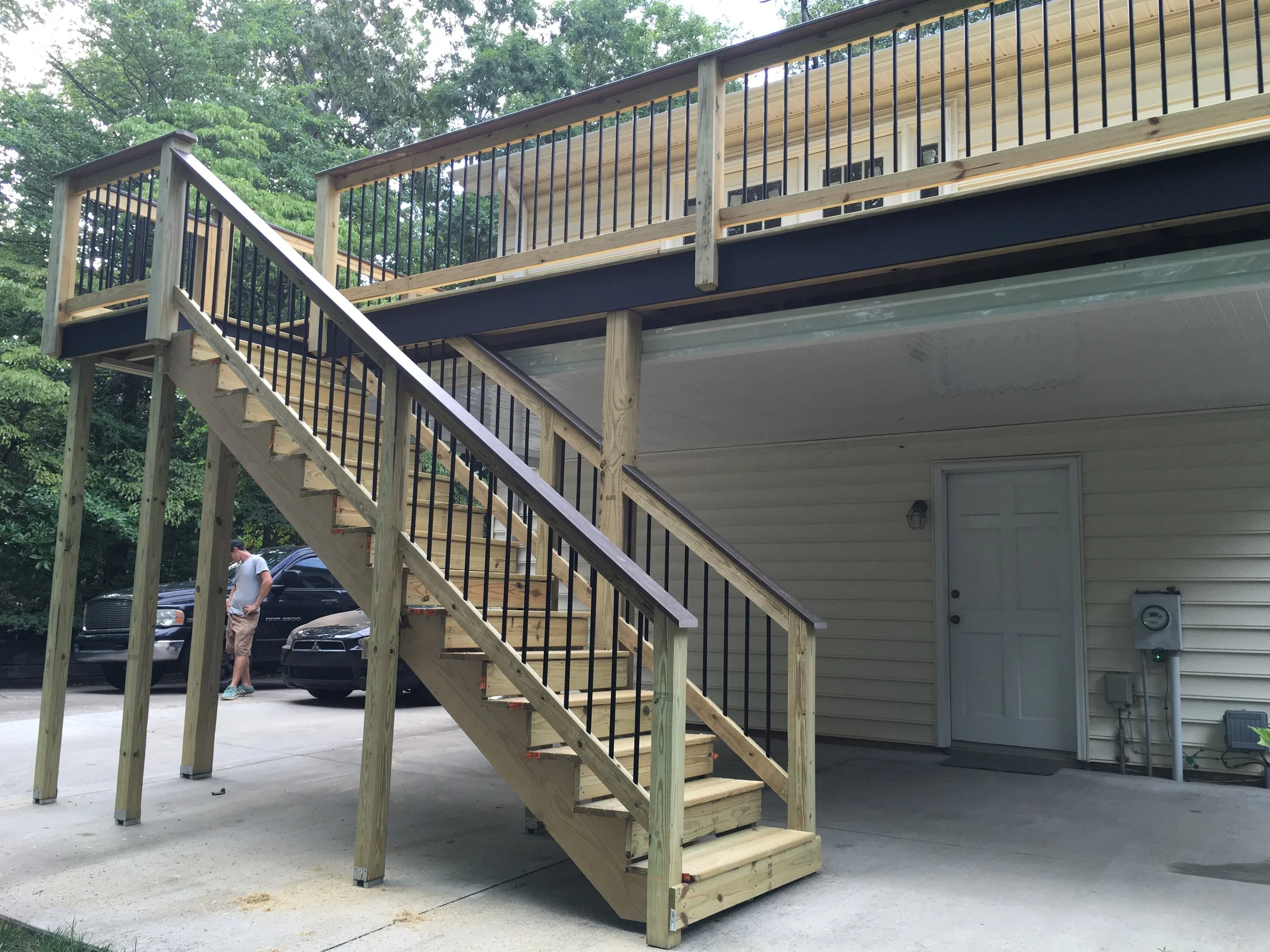 Deck stairs down to driveway with Trex composite decking top caps.