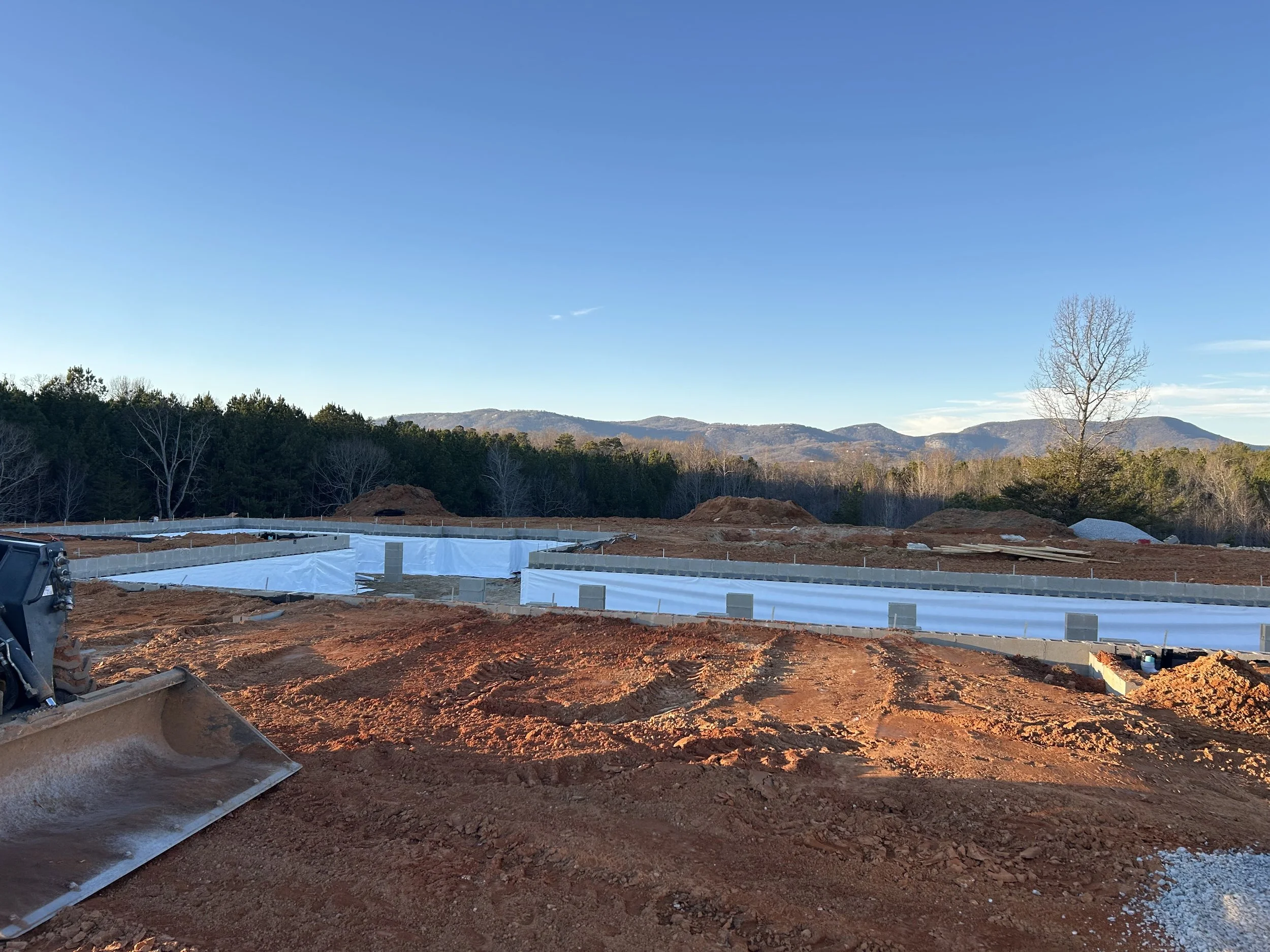 20mil poly installed on walls for beginning of crawlspace encapsulation. Foundation backfilled against.