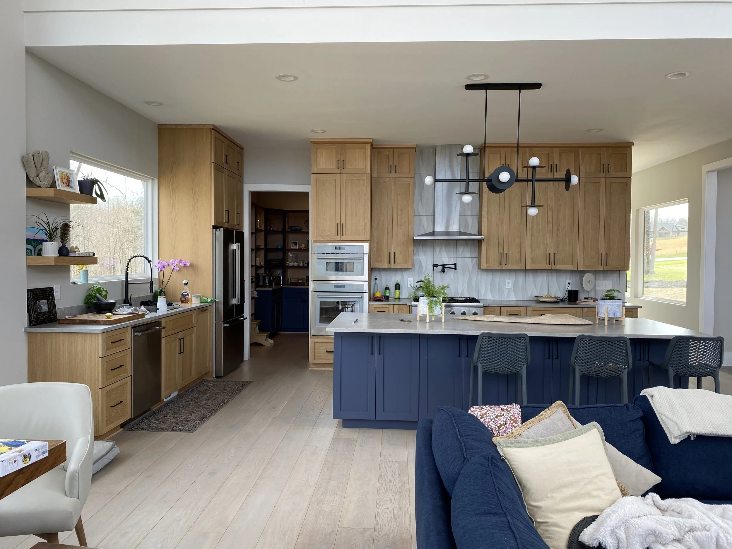 Custom kitchen cabinetry. Wide plank engineered hardwood flooring. Decorative tile backsplash.