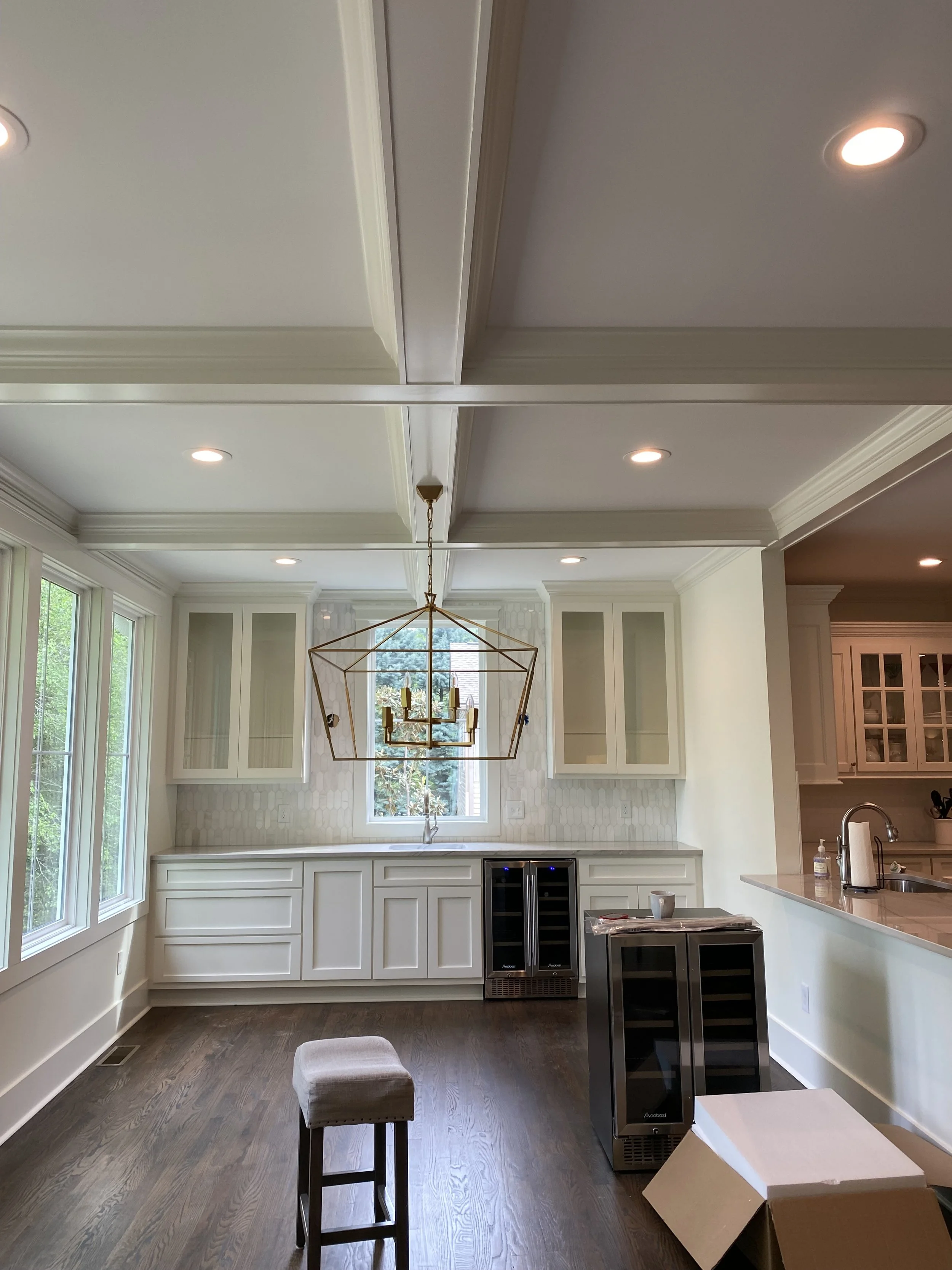 Dining room/sun room addition off of porch addition. Custom bar cabinetry. Coffered ceiling. Hardwood floors to flow seamlessly into the existing interior of the home. Wall removed to open up more to existing kitchen.