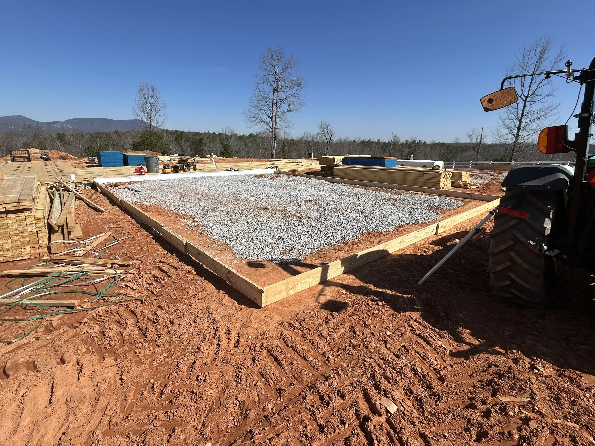 Washed stone is added to interior of garage form. Area is compacted, and wire mesh is added. 10mil poly goes over gravel.