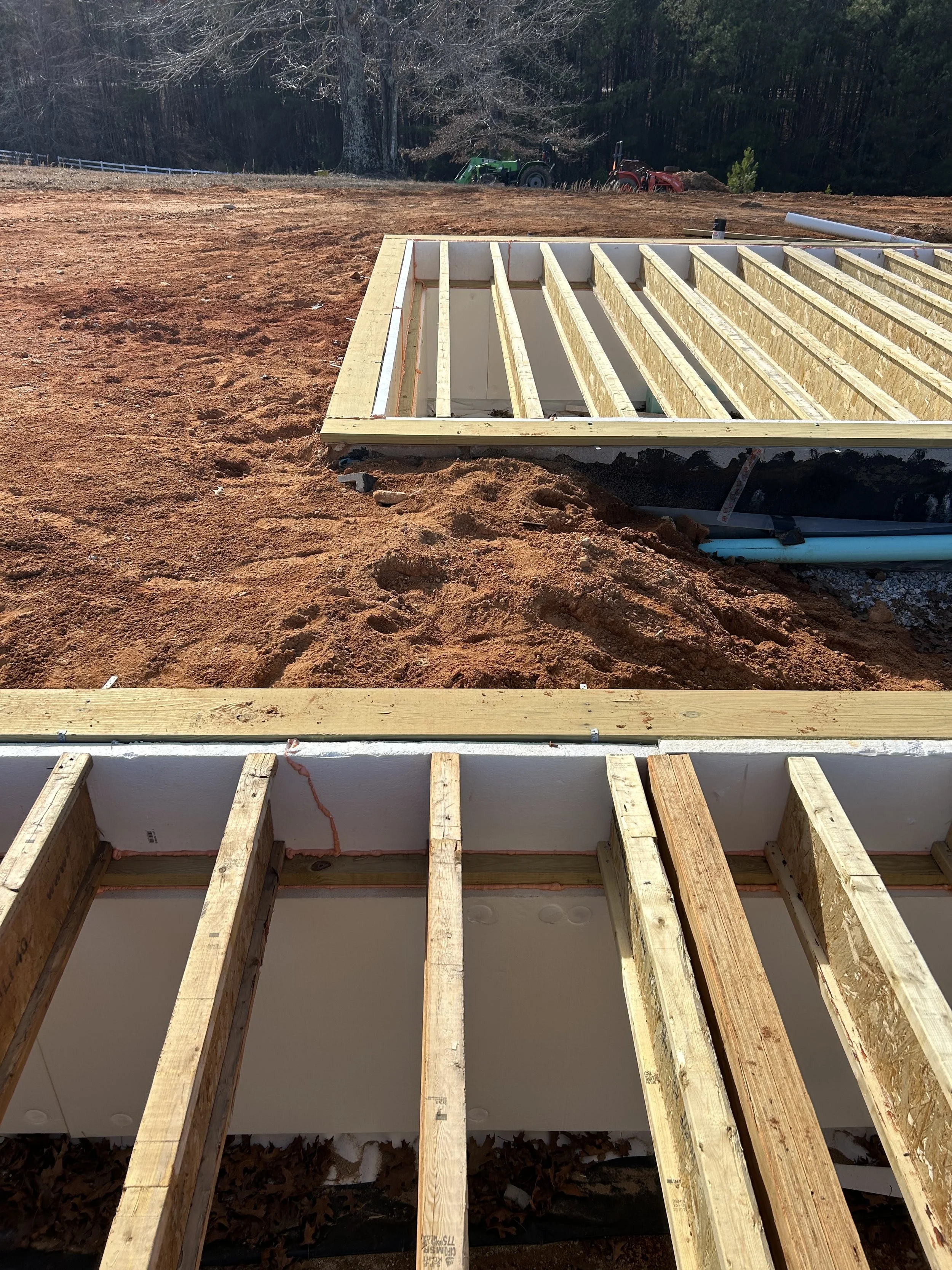 LVL flush support beams. 12" TJI floor joists hung from support beams. Beams made flush to allow for more head room in crawlspace. Crawlspace access to be from door in the floor of the finished home.