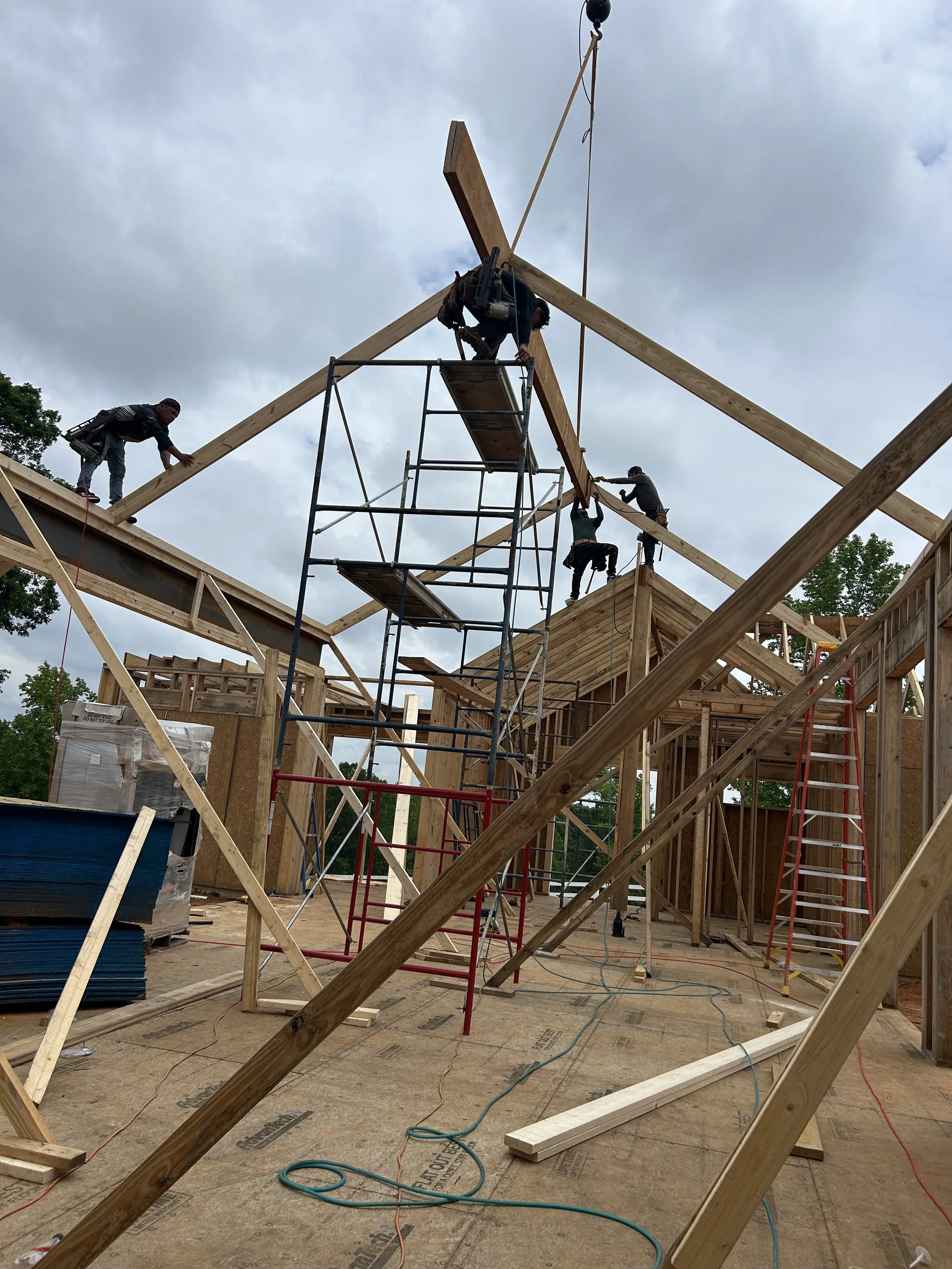 Double 16" LVL ridge beam set in place by crane for living room ceiling.
