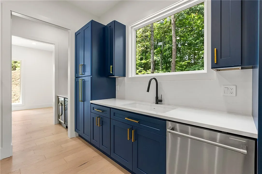Wide plank LVP flooring. Semi-custom cabinets with Quartz counters with waterfall edges on island. 