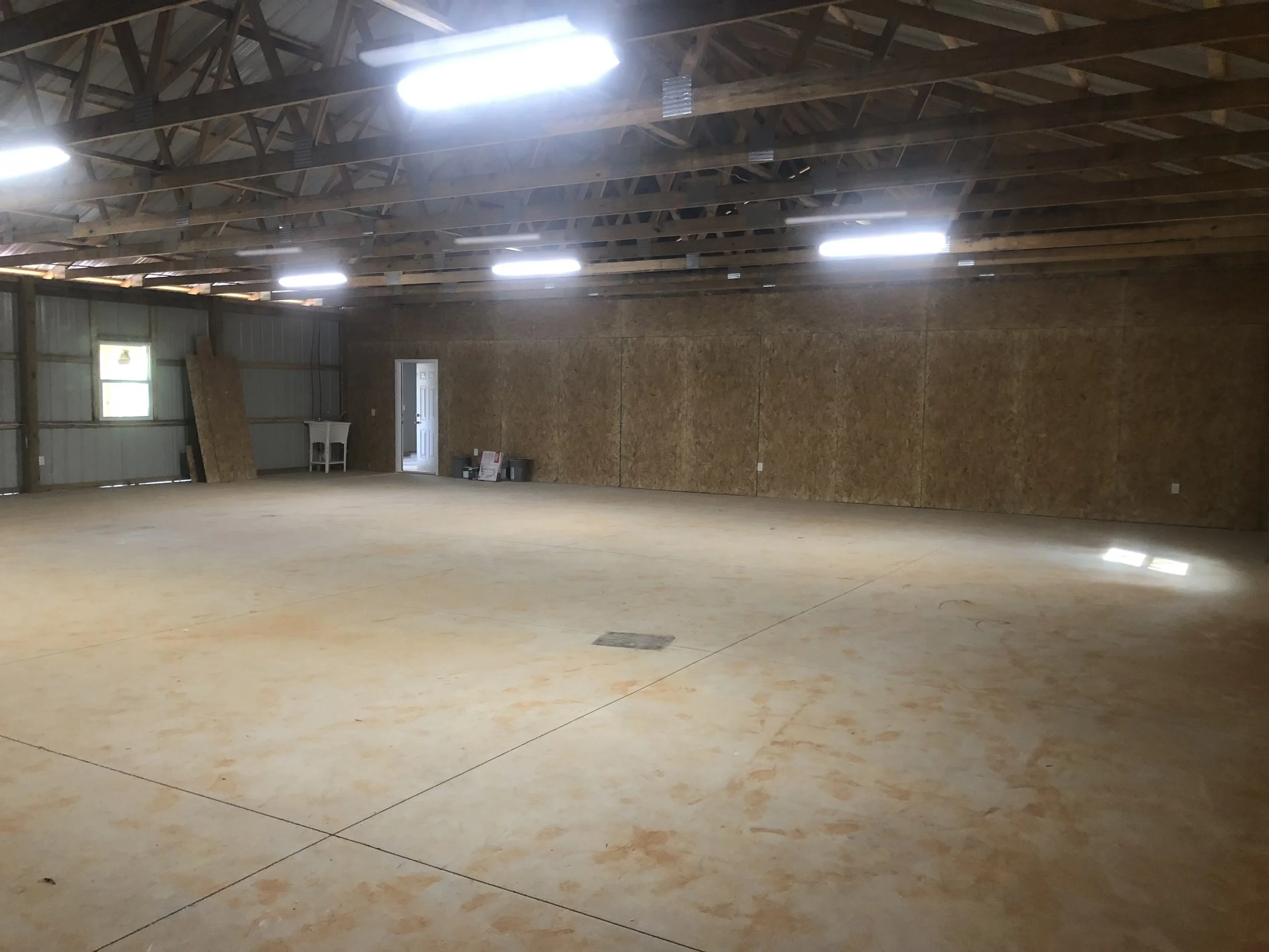 Interior of the shop portion of a large pole barn.