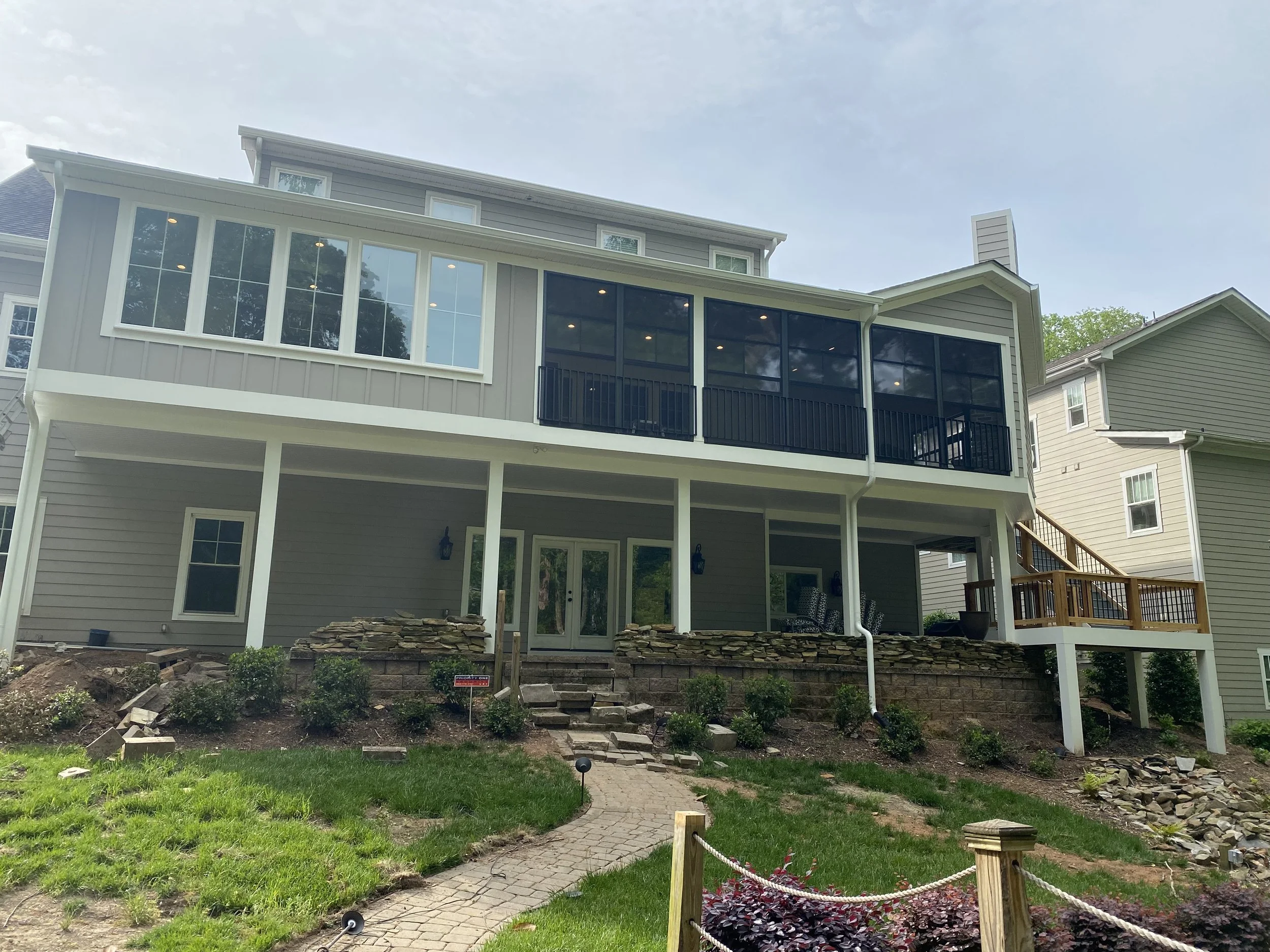 Large three season porch addition with dining room/sun room addition. Eze Breeze window system with aluminum safety rail outside window units. Fiber cement plank siding. 