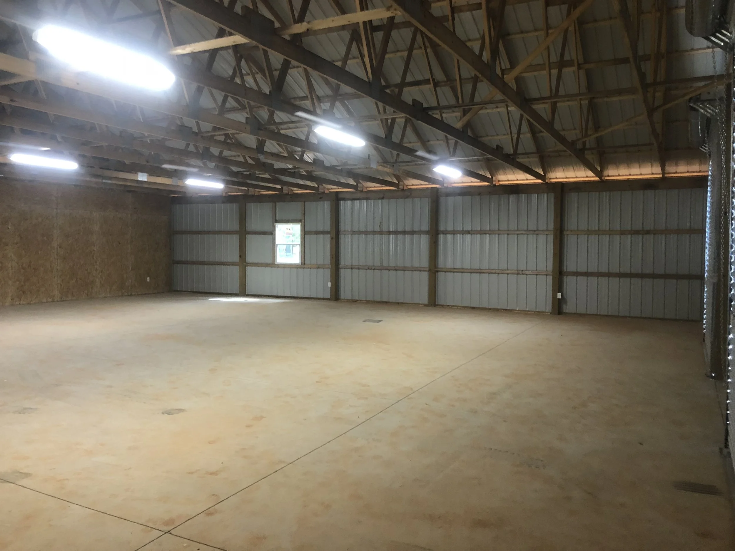 Interior of the shop portion of a large pole barn.