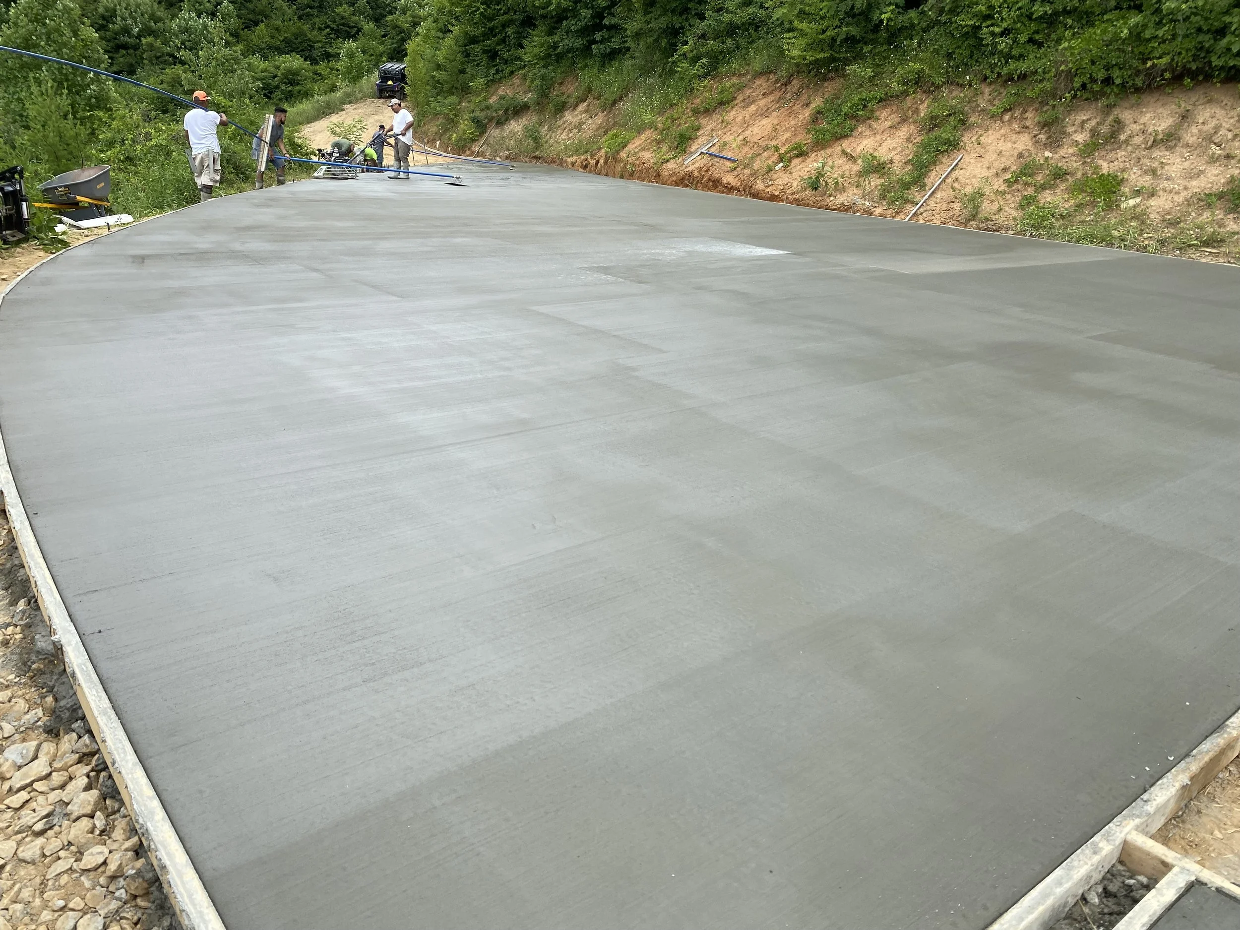Concrete driveway formed and poured. Broom finish.