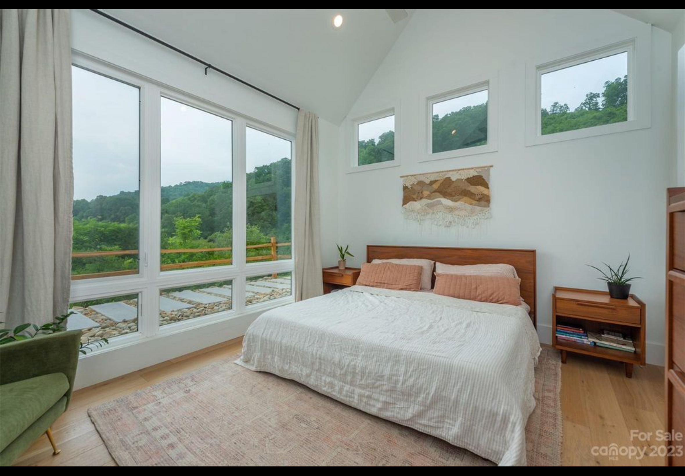Bedroom one of two bedroom two bath tiny home mountain getaway. Vaulted ceiling. Vinyl casement windows with lower fixed transoms. LVP engineered hardwood flooring with real wood top layer.