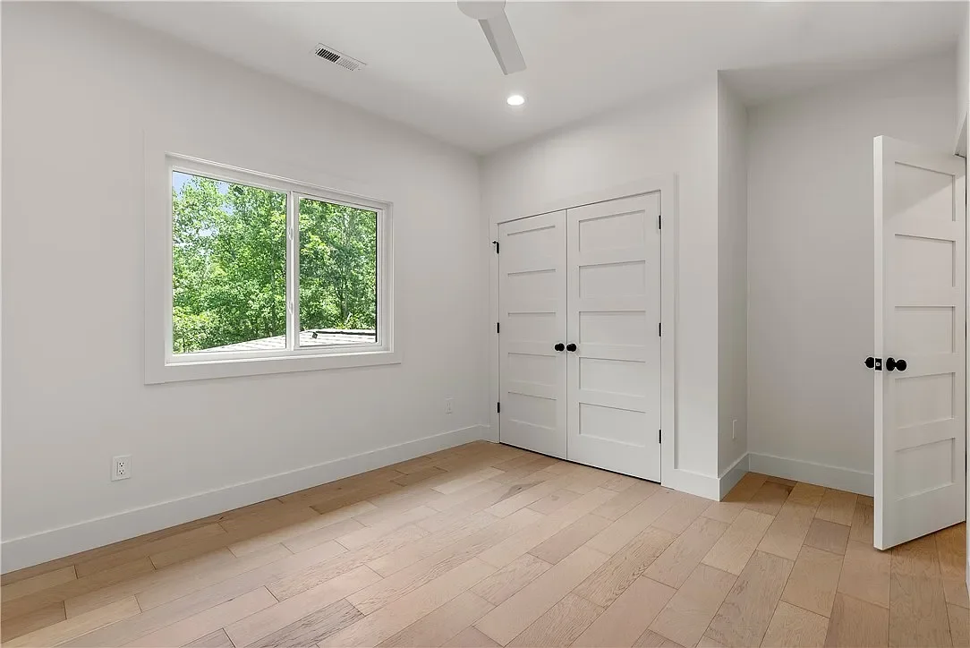 Wide plank LVP flooring. Sliding window. 8' solid core wood doors.