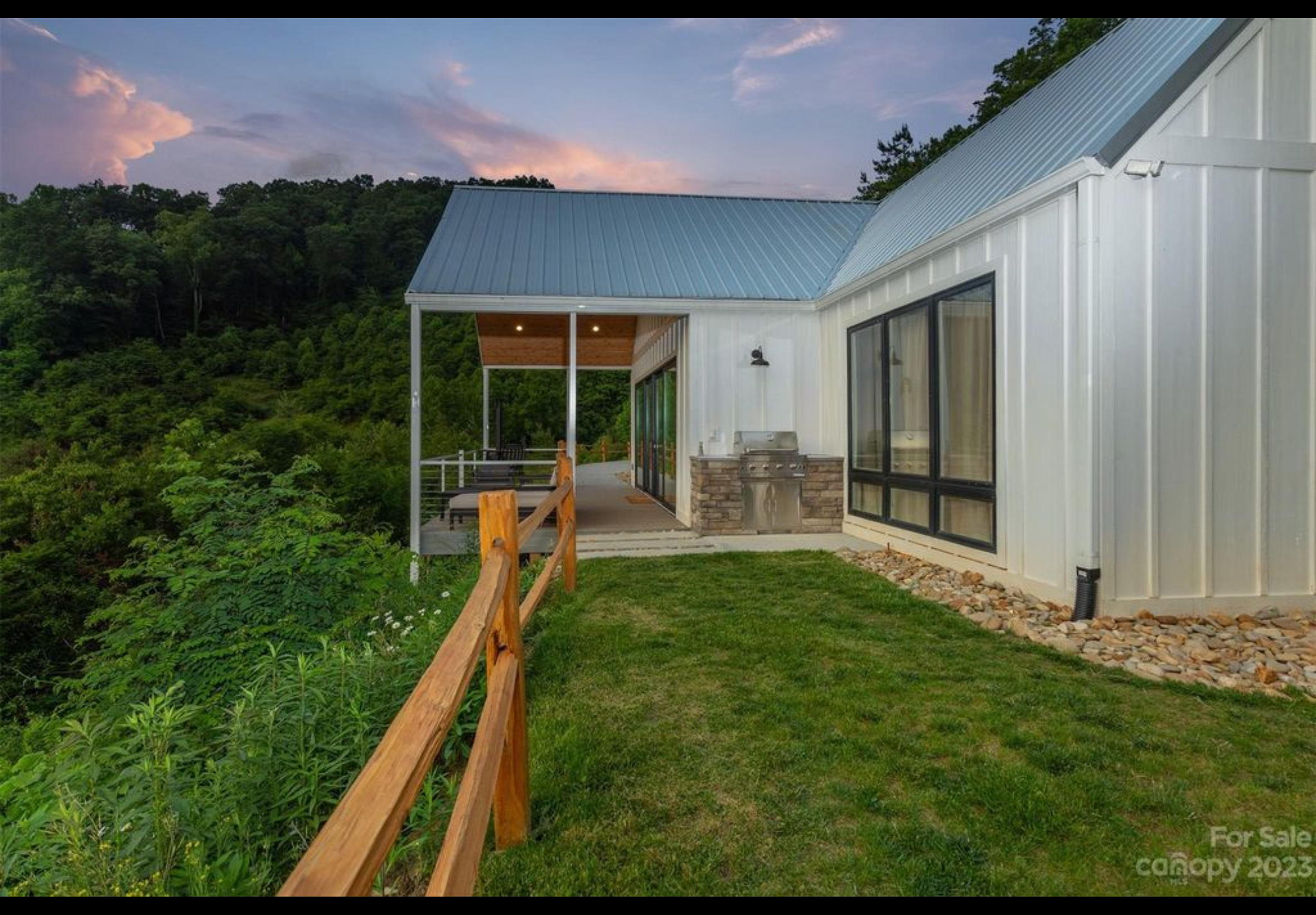 Cedar split rail fence. Built in outdoor kitchen with concrete top and decorative stone veneer.