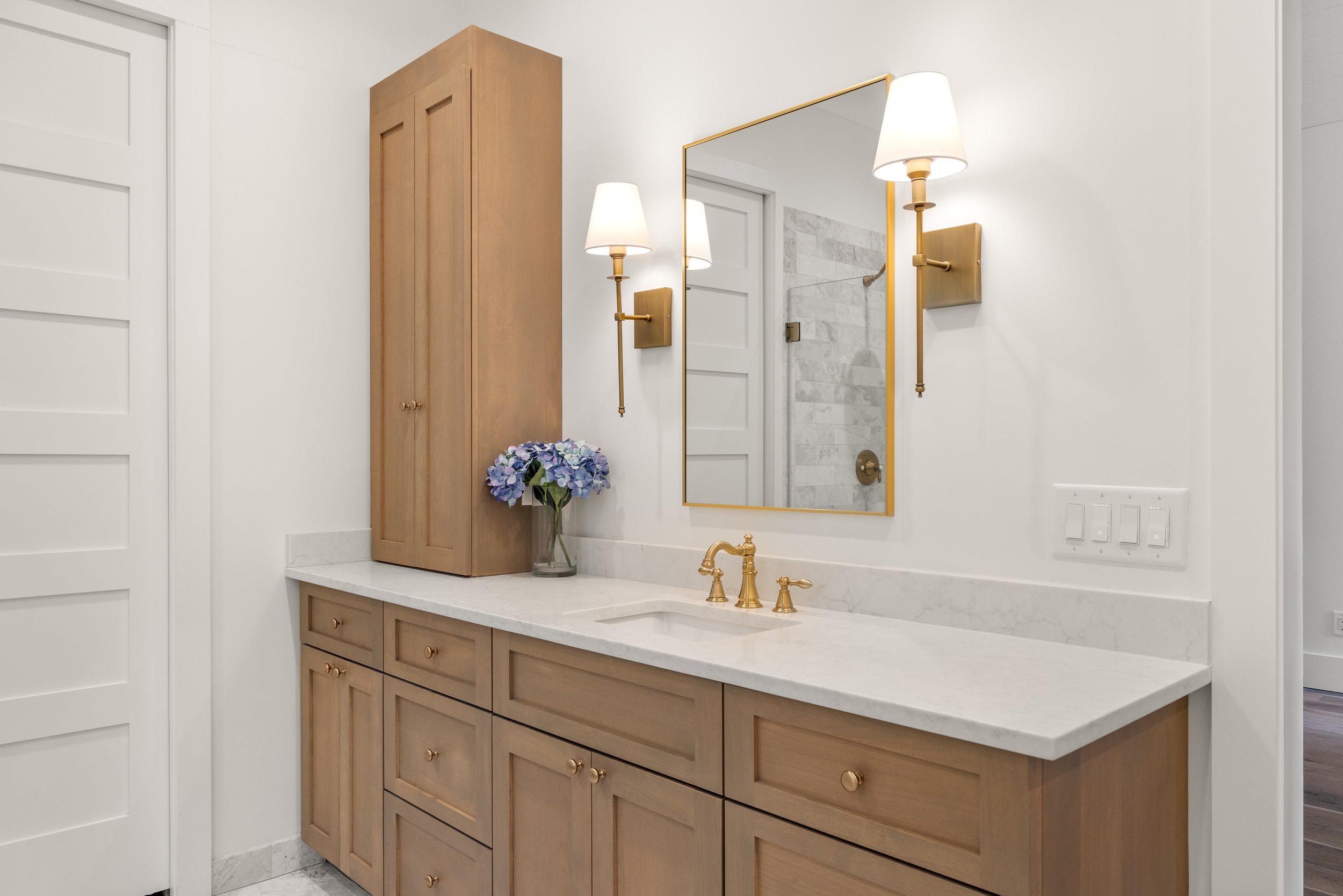 Custom built vanities with quartz counters.