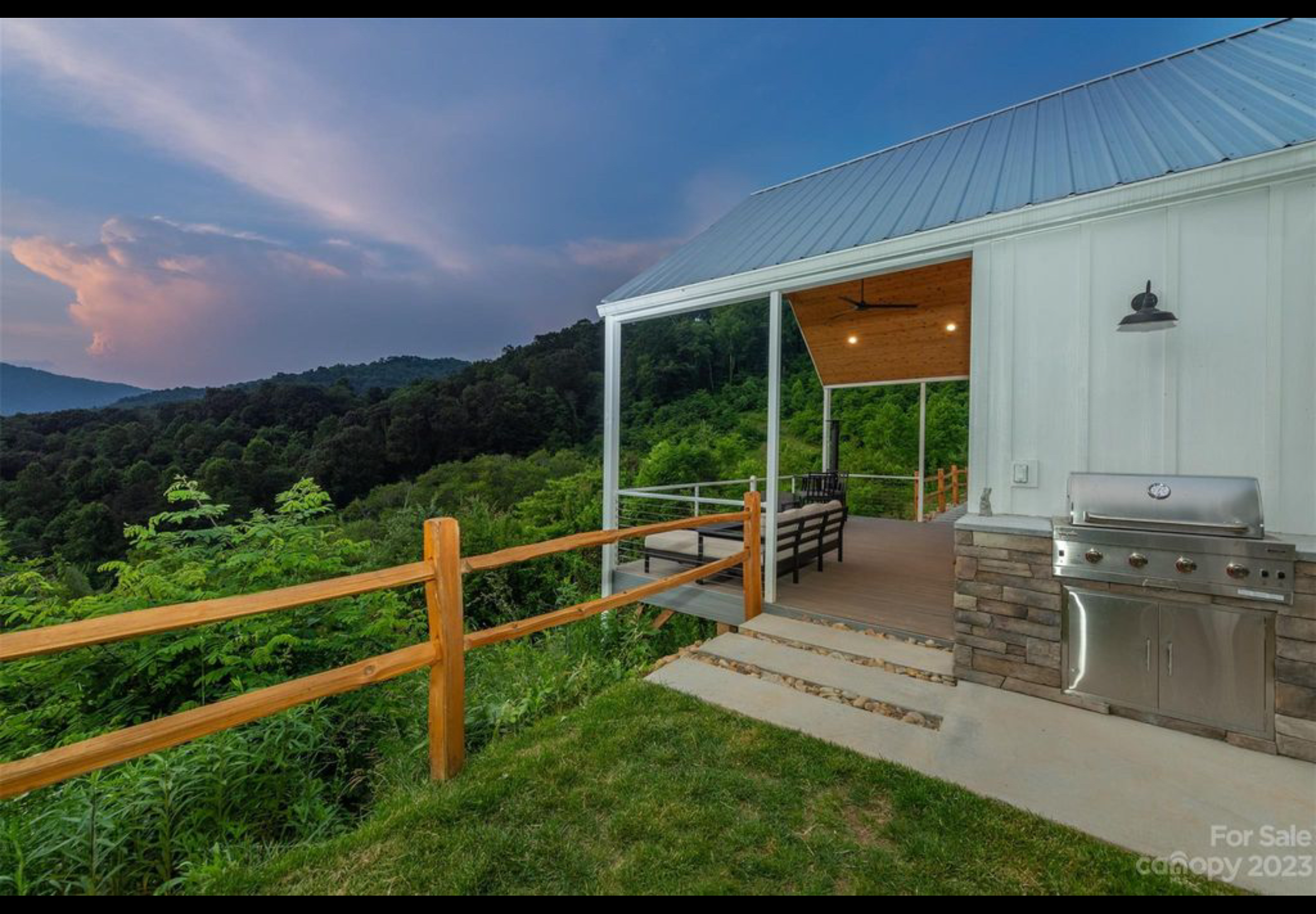 Finished front porch deck. Extruded aluminum handrail with cable railing. Trex Enhanced Naturals decking installed with Trex hidden fasteners. Cedar split rail fence. Built in outdoor kitchen with concrete top and decorative stone veneer.