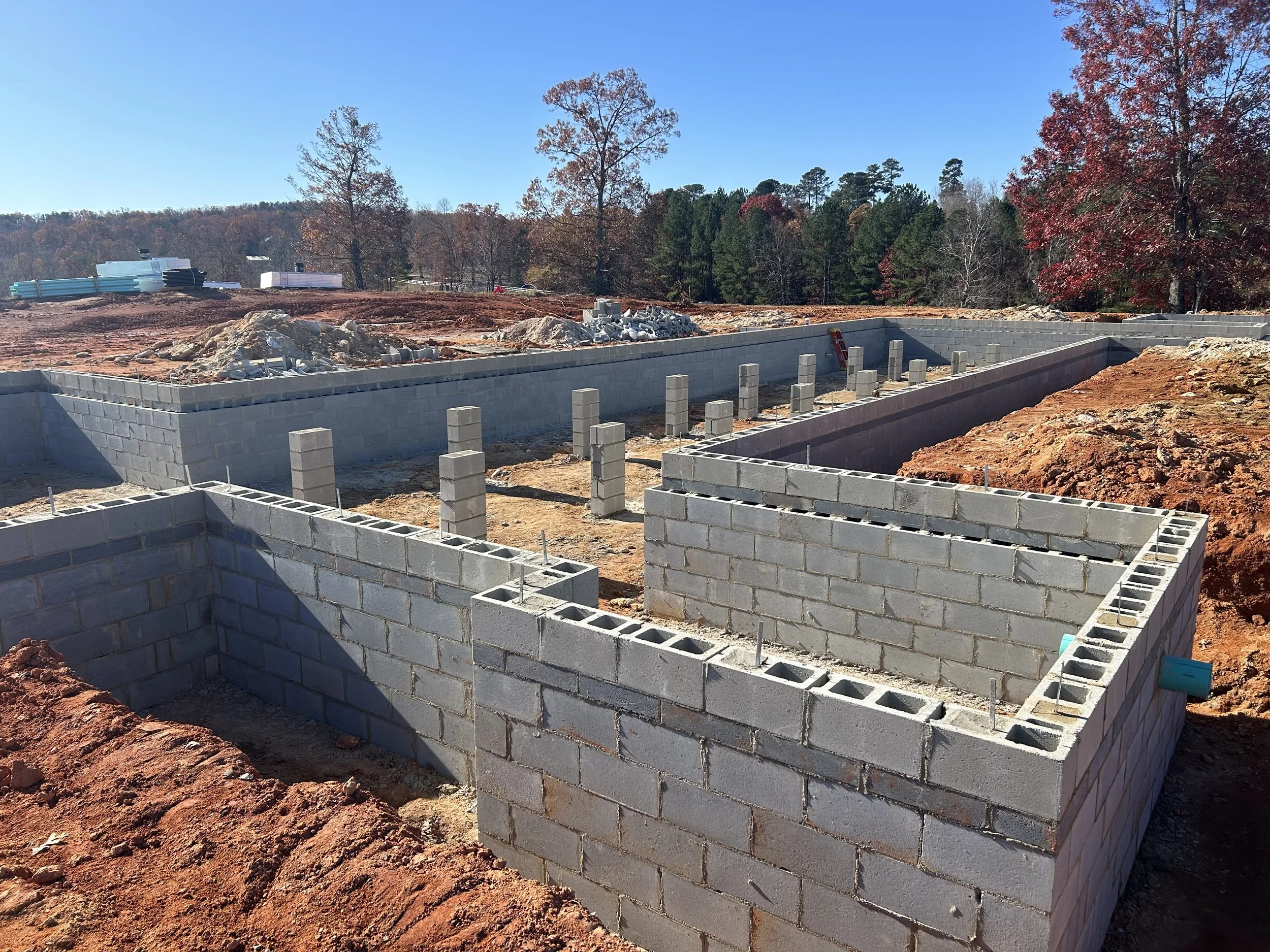 Block complete. 12" block to support floor framing weight. 8" block set flush with exterior of foundation to cover floor framing later, which allows us to have the outside grade higher up on the home, allowing for less or no steps upon entering the h
