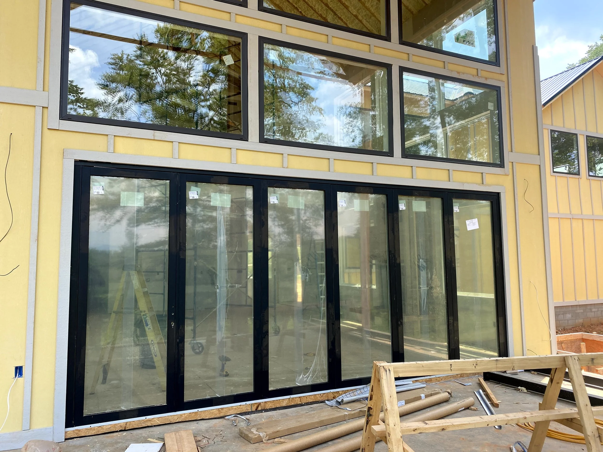 18'x8' folding Panoramic door. Fiber cement board and baton siding.