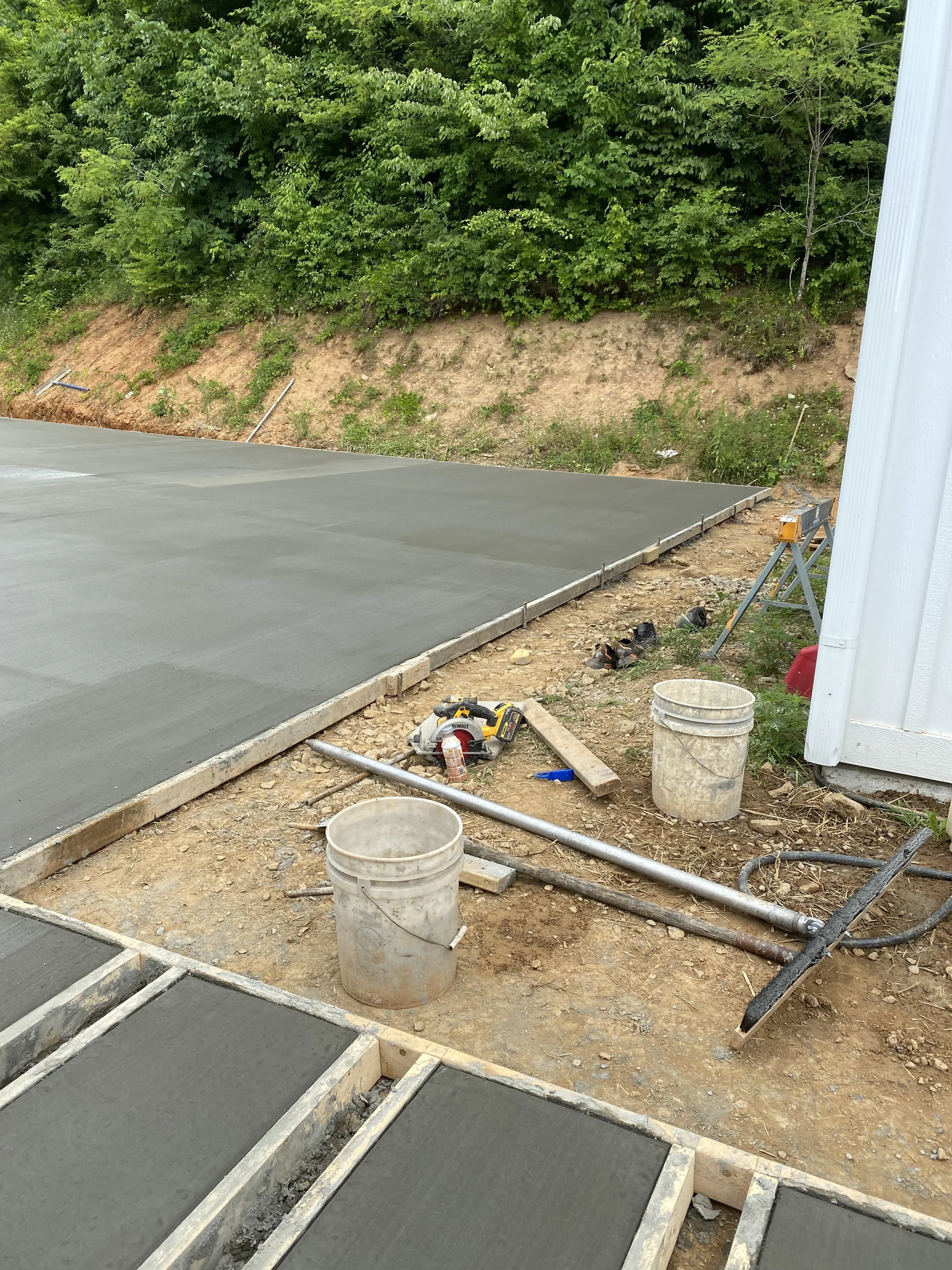 Concrete driveway with decorative step walkway formed and poured to new home.