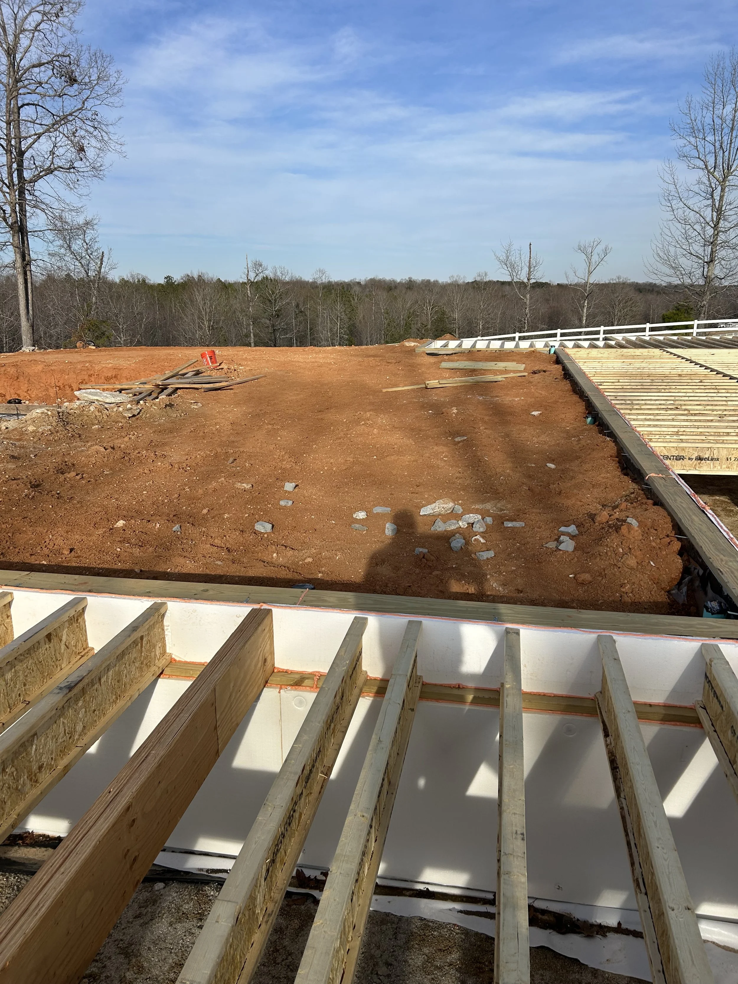 LVL flush support beams. 12" TJI floor joists hung from support beams. Beams made flush to allow for more head room in crawlspace. Crawlspace access to be from door in the floor of the finished home.