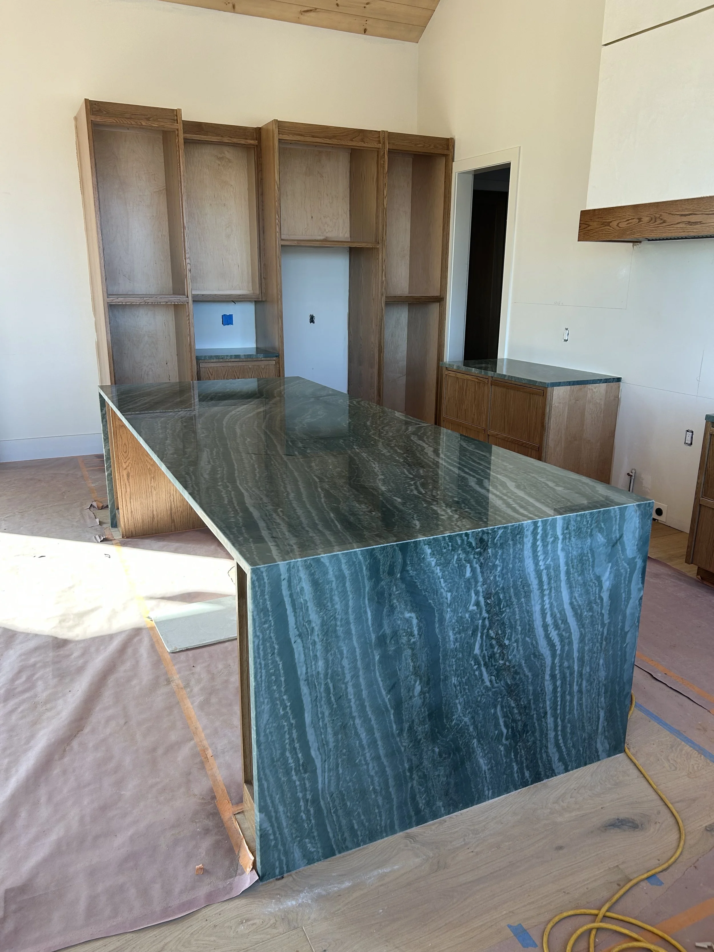 Quartzite countertops with waterfall edges on island.