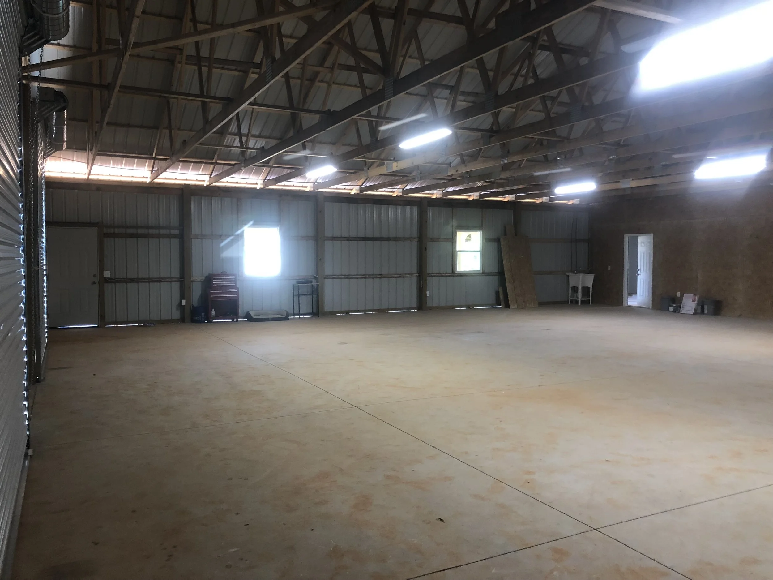 Interior of the shop portion of a large pole barn.